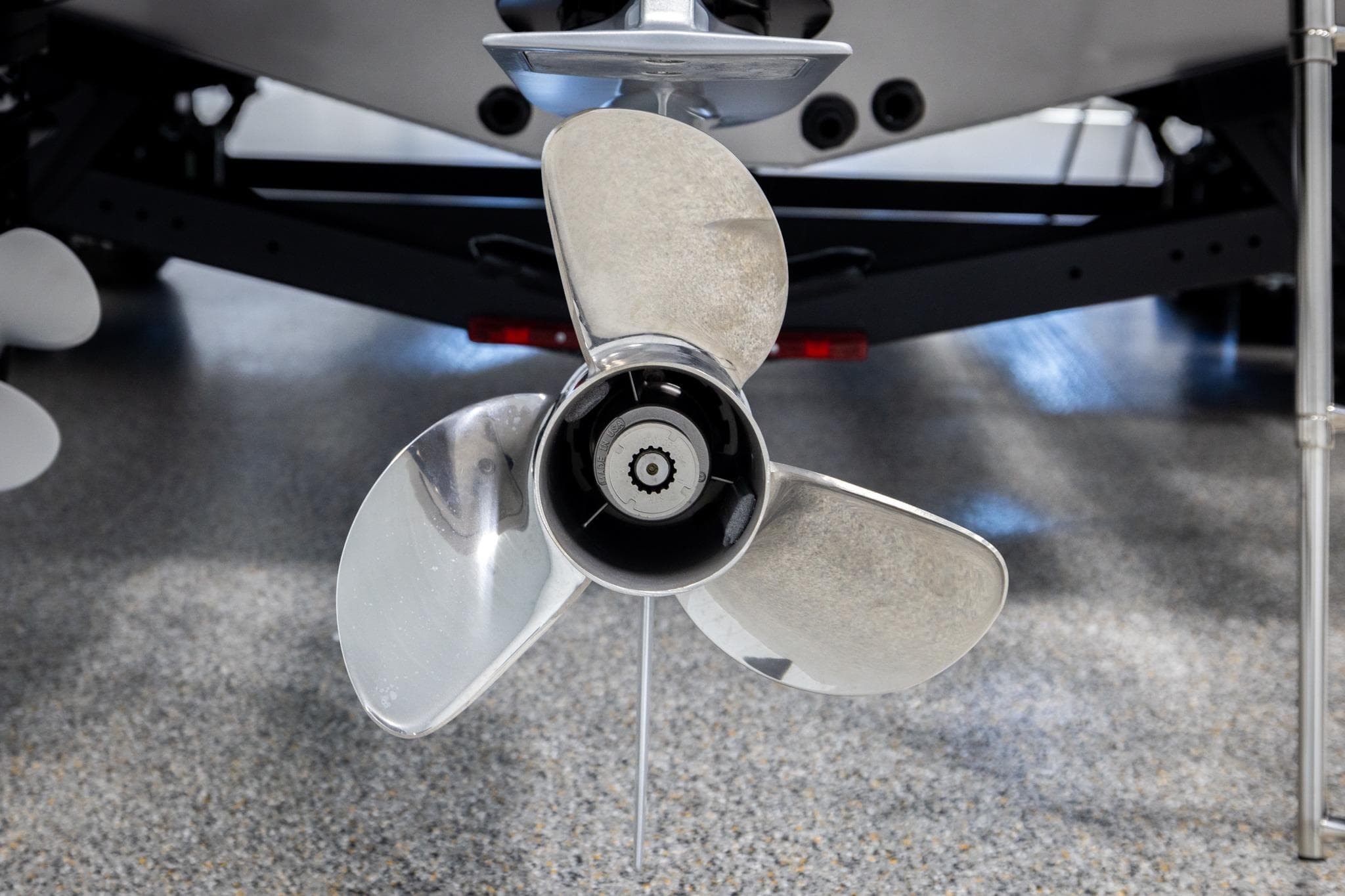 2026 Lund 2075 Impact XS boat propeller on display in a showroom.