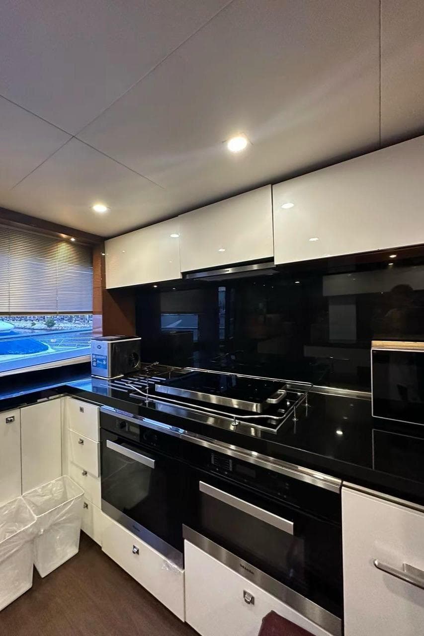 Modern kitchen interior on 2013 Princess M Class 32M yacht, featuring sleek cabinetry and appliances.