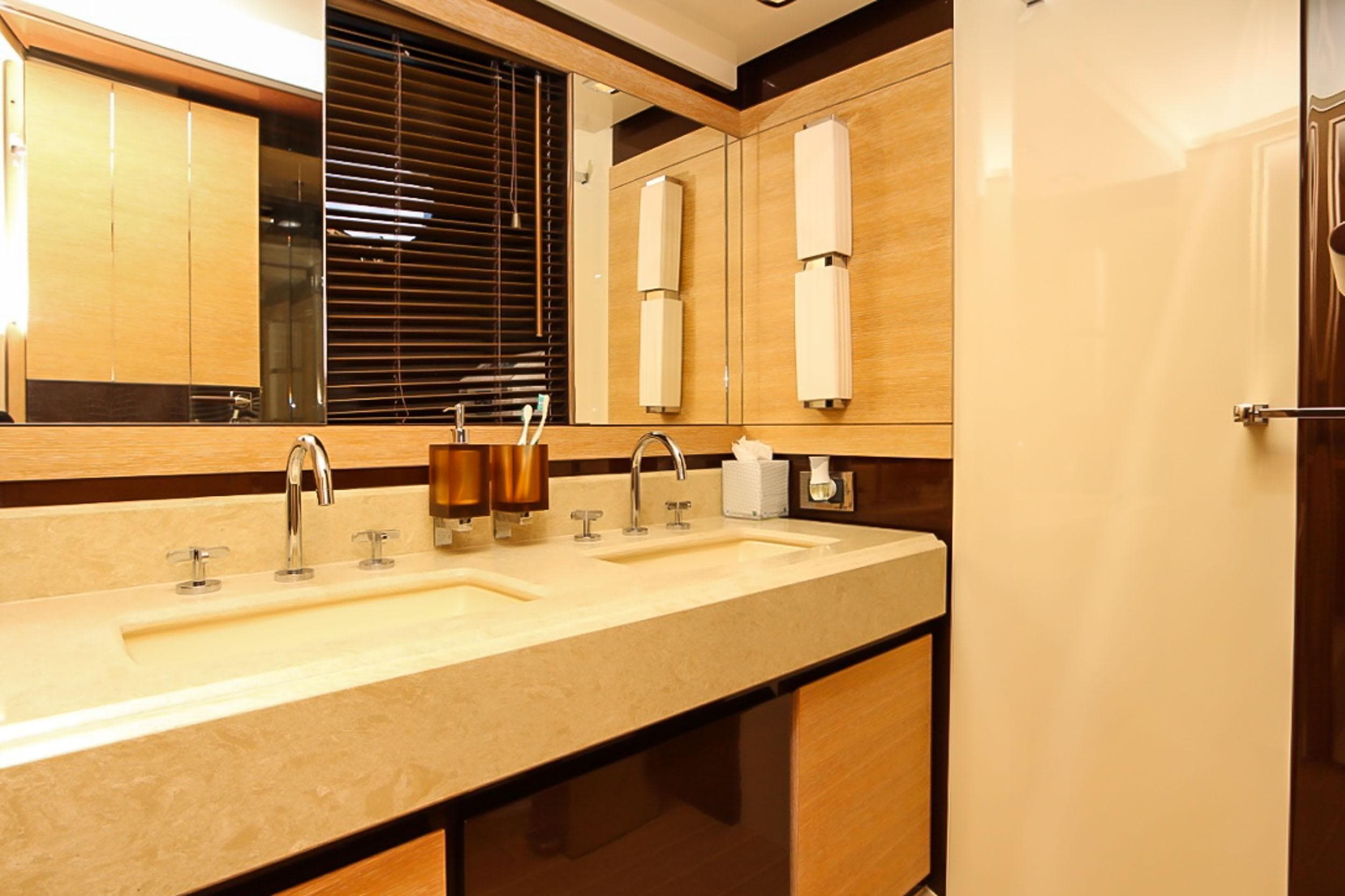 Luxurious bathroom interior on a 2011 Azimut 70 yacht, featuring dual sinks and modern fixtures.