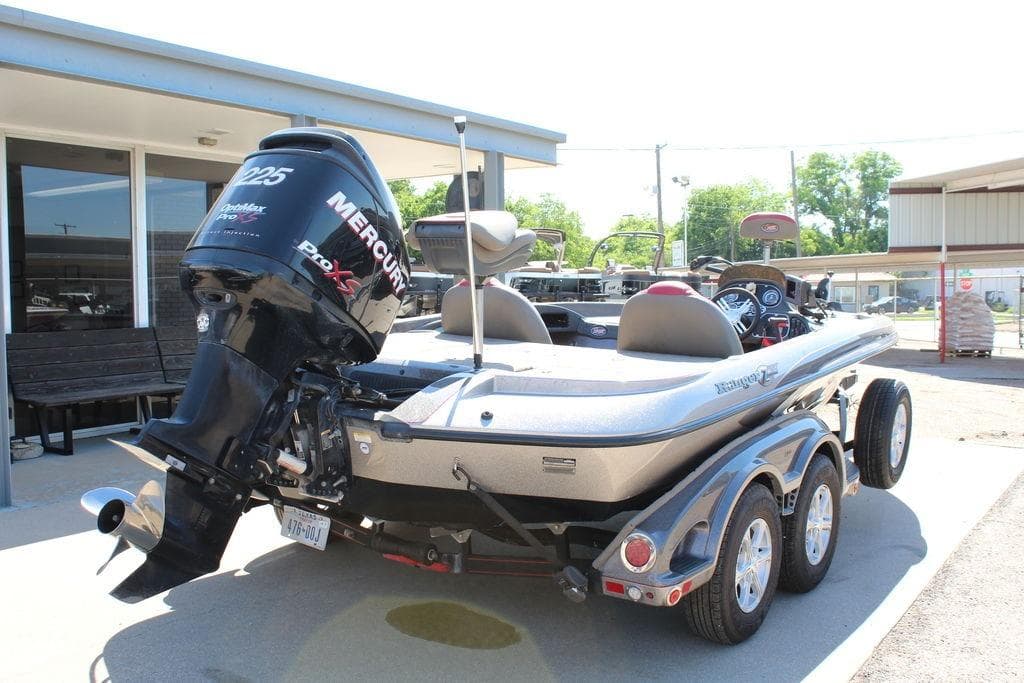 2011 Ranger Z120 Comanche boat with Mercury Pro XS engine, parked outdoors.