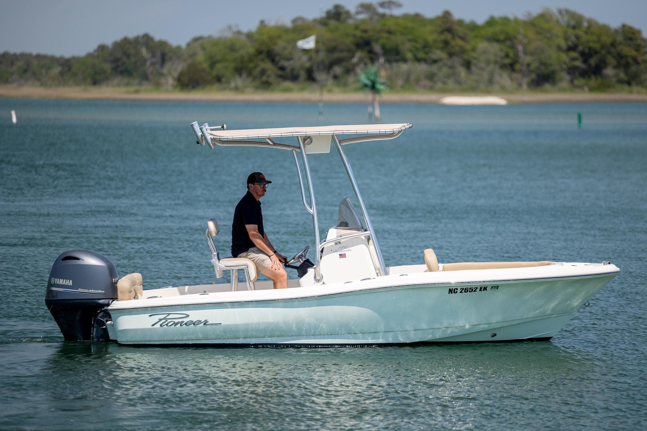 2019 Pioneer 180 Islander boat cruising on a calm lake with a Yamaha engine.