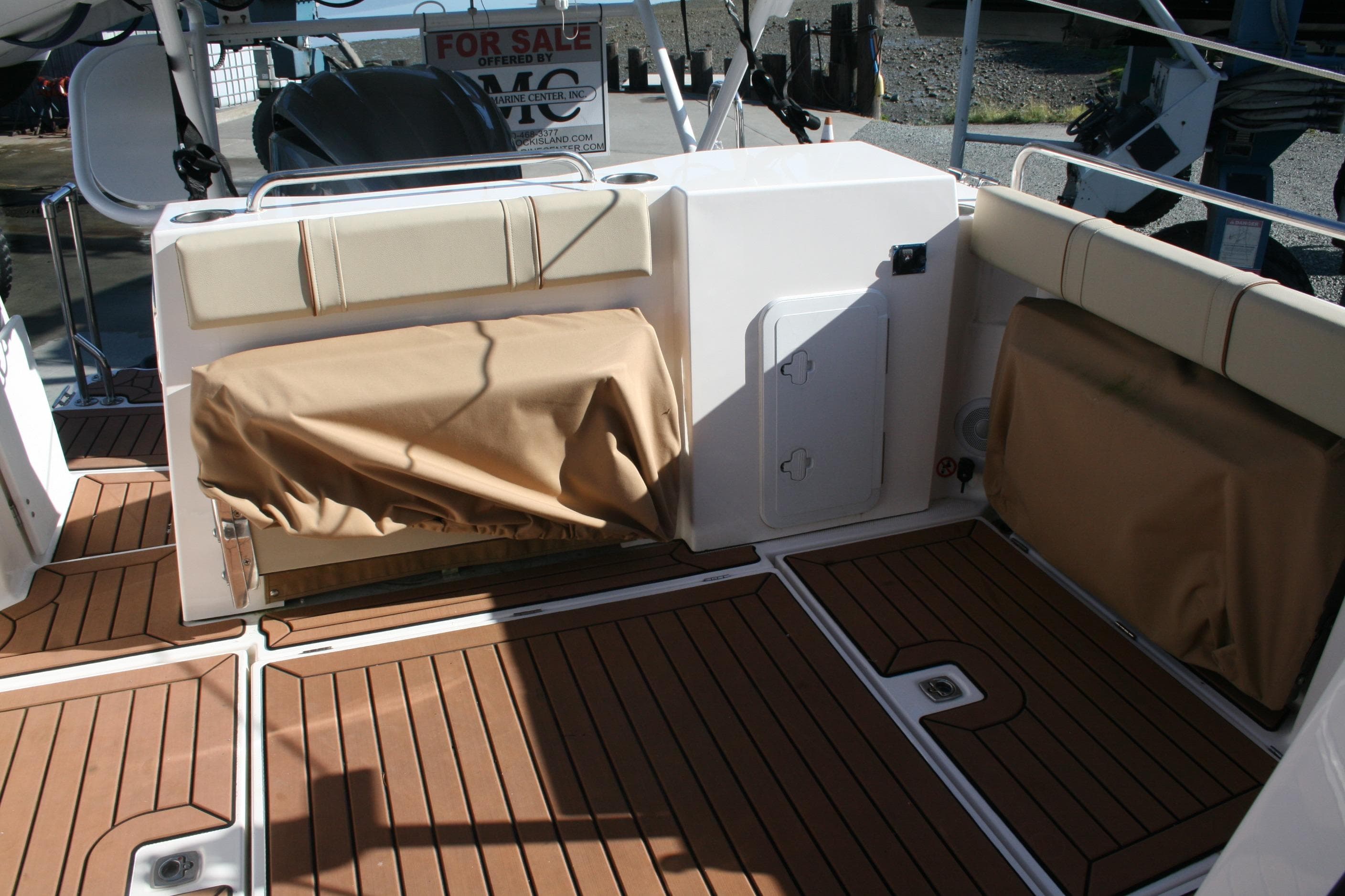 2024 Ranger Tugs R-25 boat deck with cushioned seating and wood-style flooring.