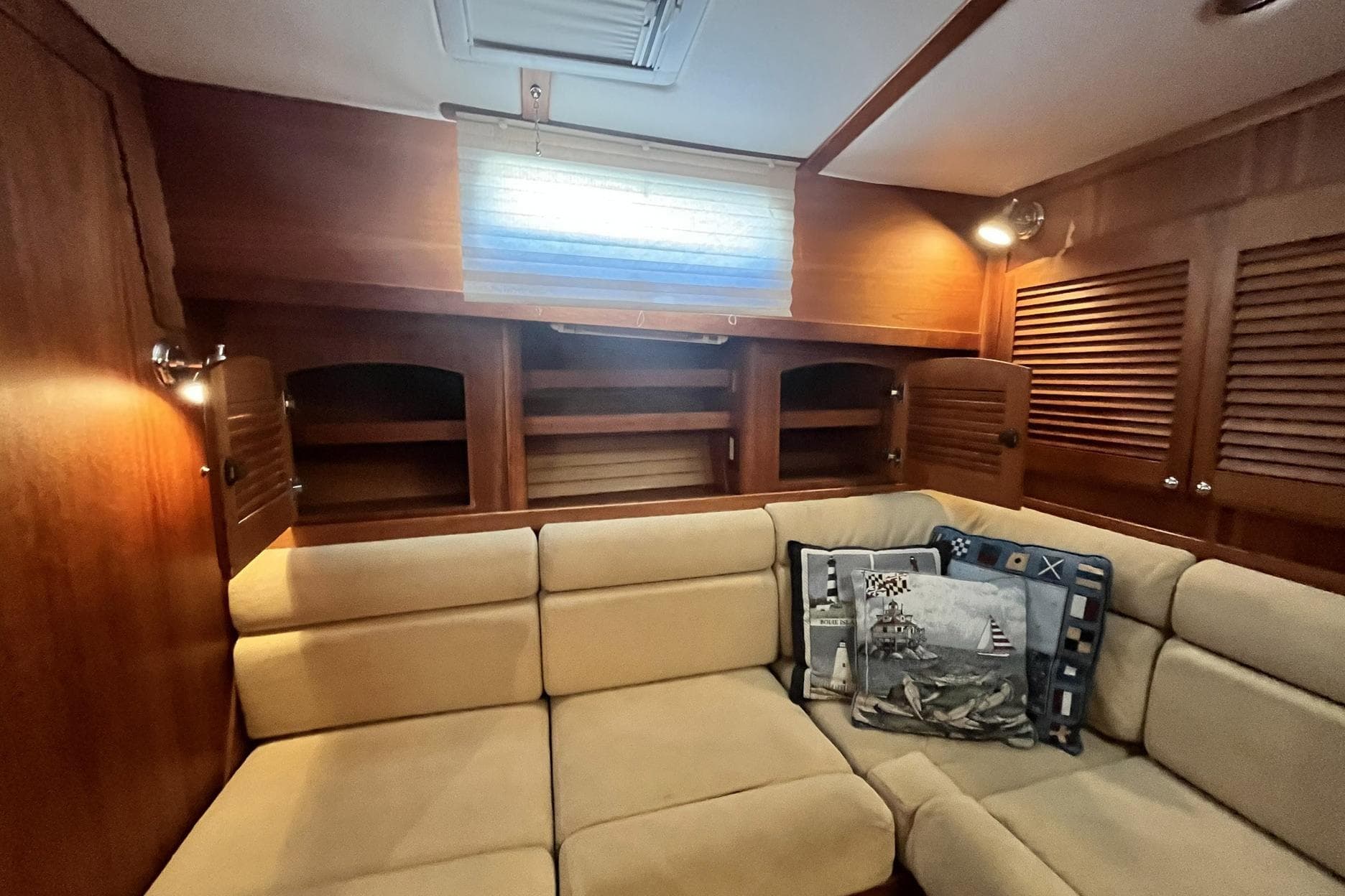 Interior of 2007 Sabre 34 Express yacht with beige seating and nautical-themed pillows.