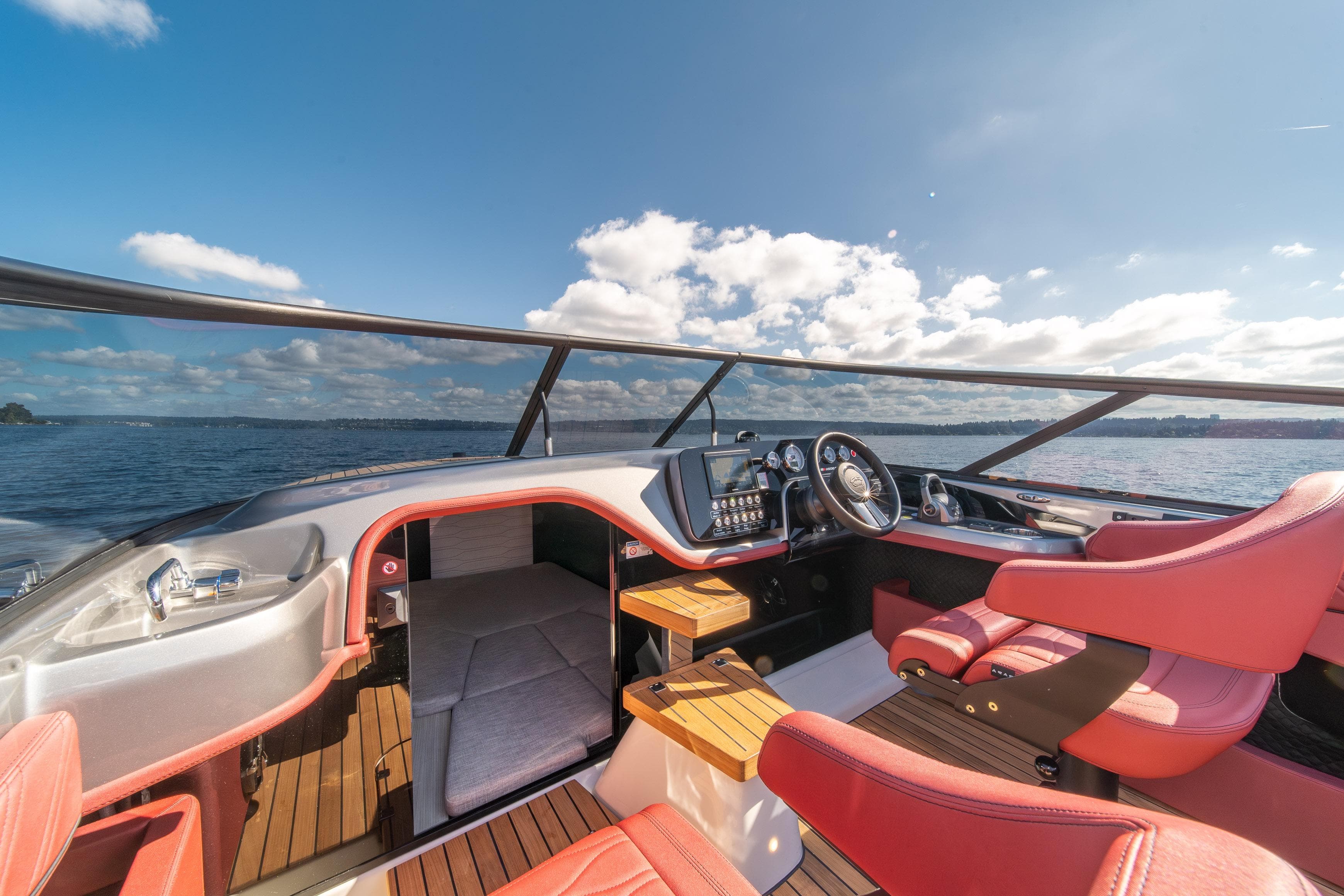 2026 Cranchi E26 Classic yacht interior with red seats and modern dashboard on open water.