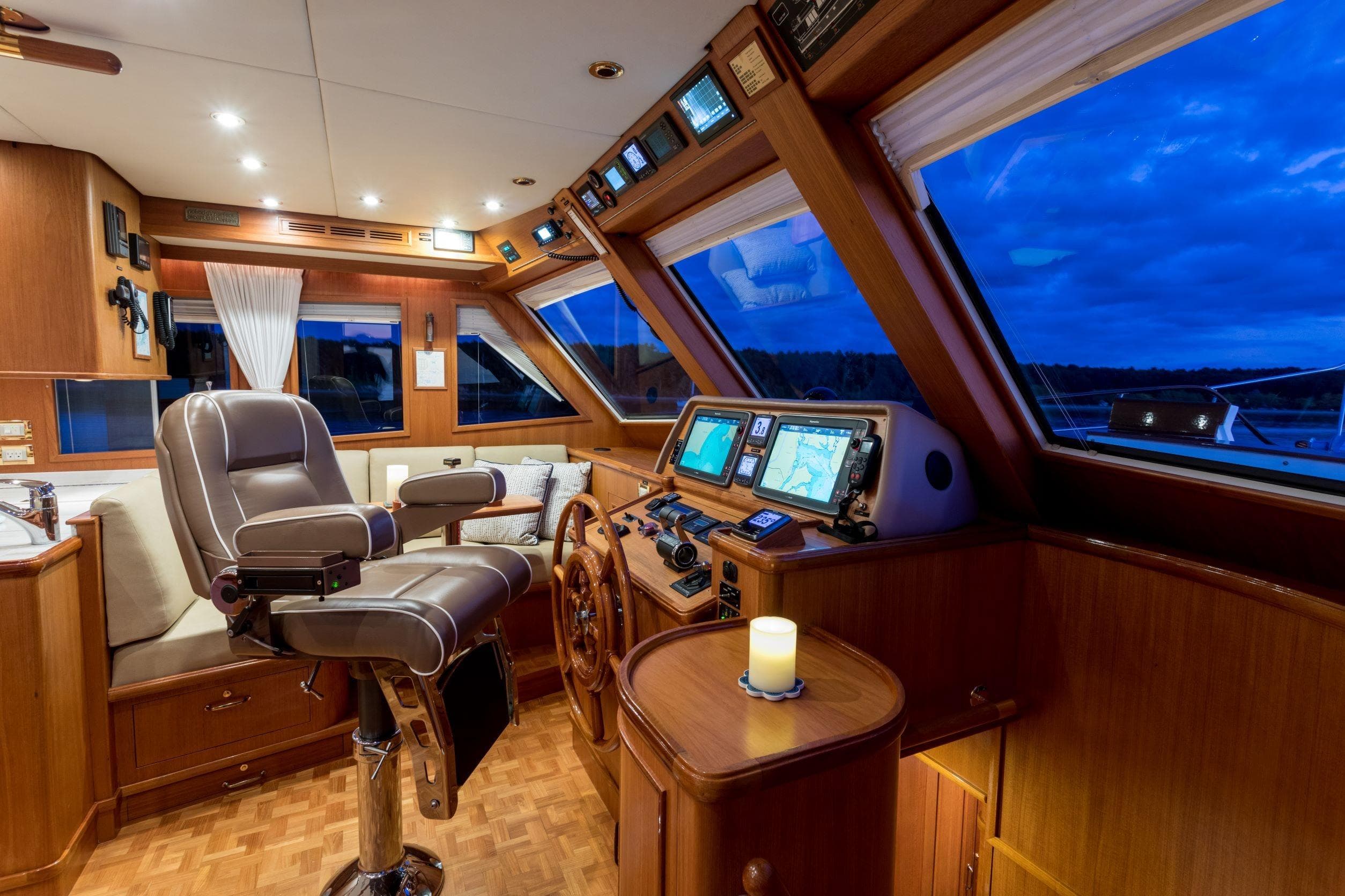 Luxurious helm of 2006 Grand Banks 59 Aleutian RP yacht with navigation equipment.
