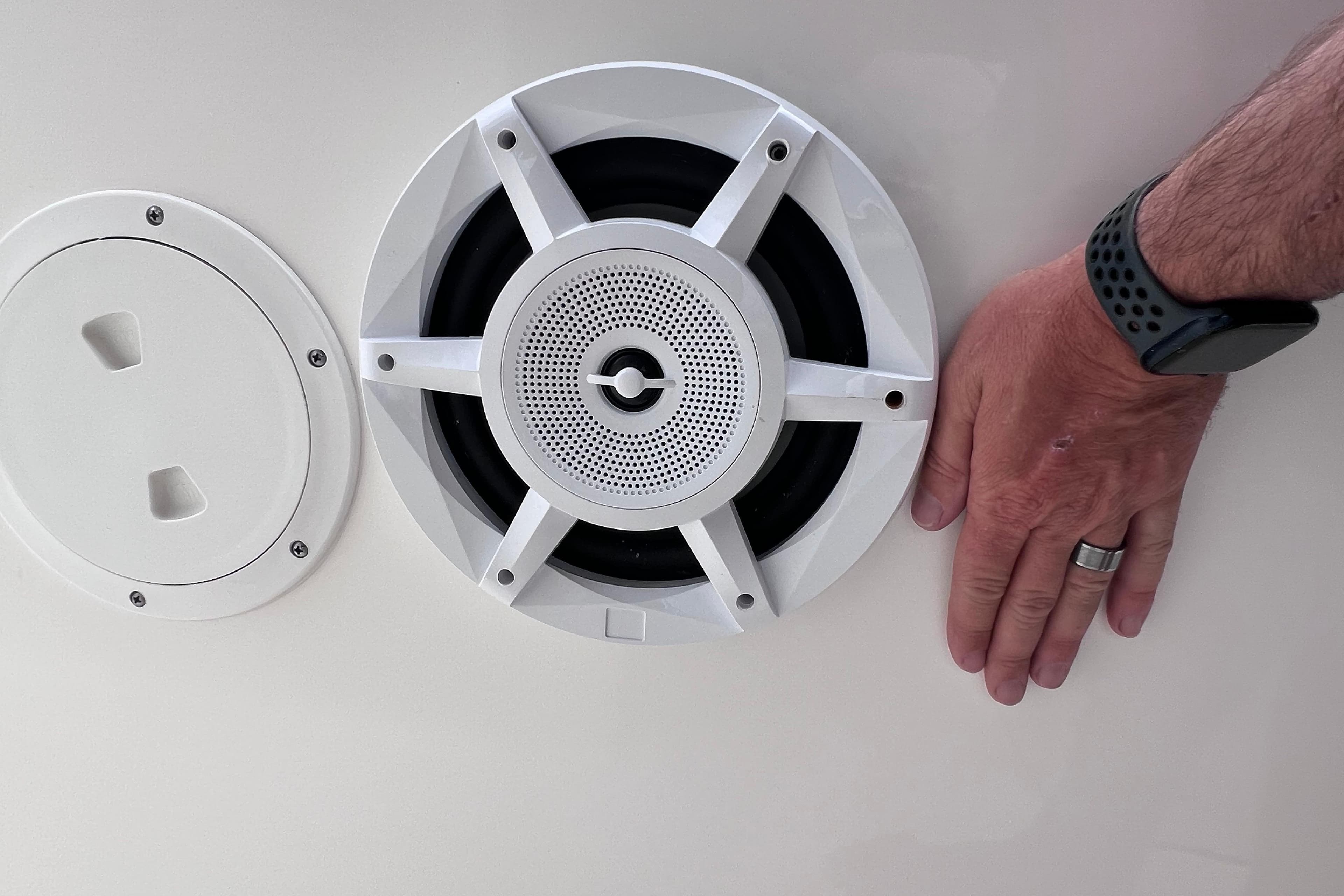 Speaker and hand on 2022 Pursuit S 288 Sport boat interior.