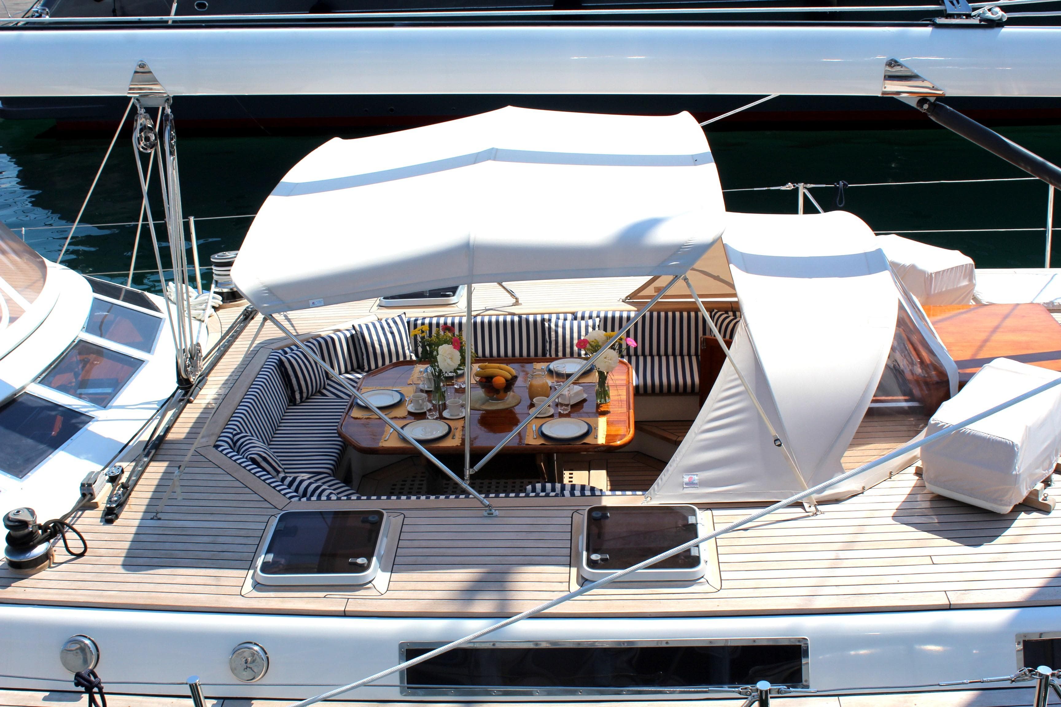 1988 Motorsailer Brooke Marine with elegant outdoor dining setup on deck.