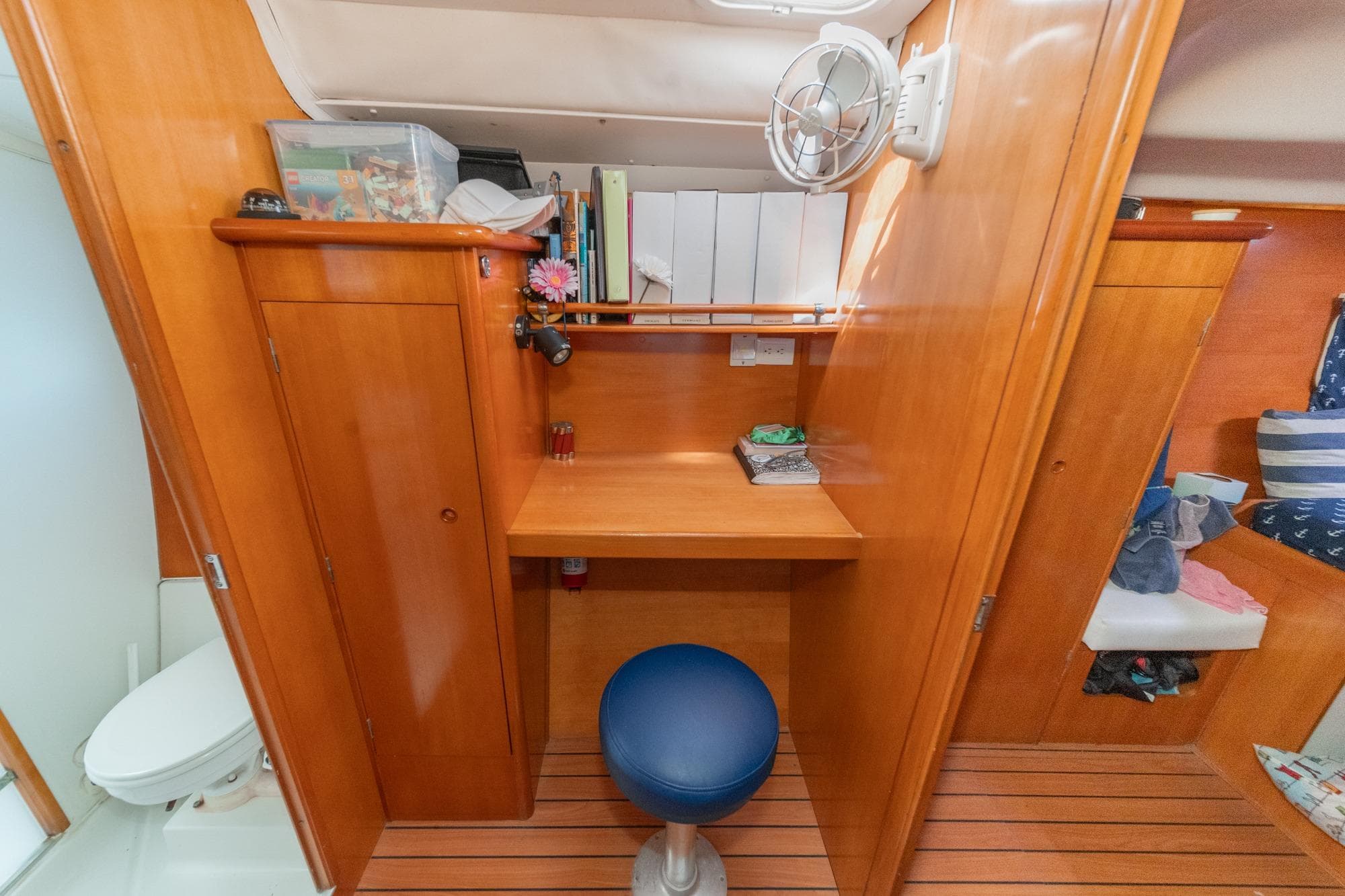 Interior of 2004 Lagoon 380 yacht with wooden cabinetry and compact workspace.