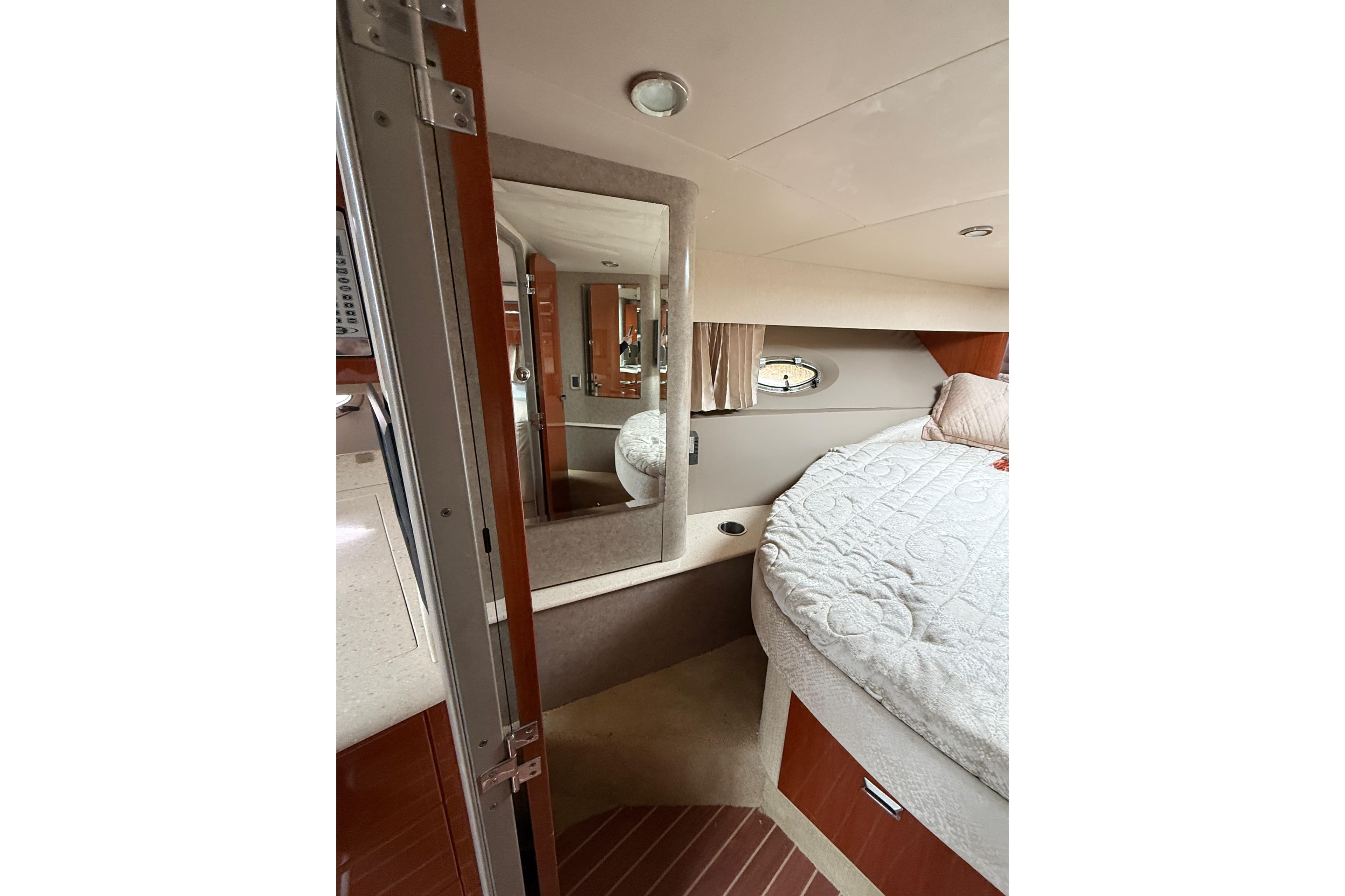 Interior of 2006 Formula 40 Performance Cruiser with cozy bed and mirror.