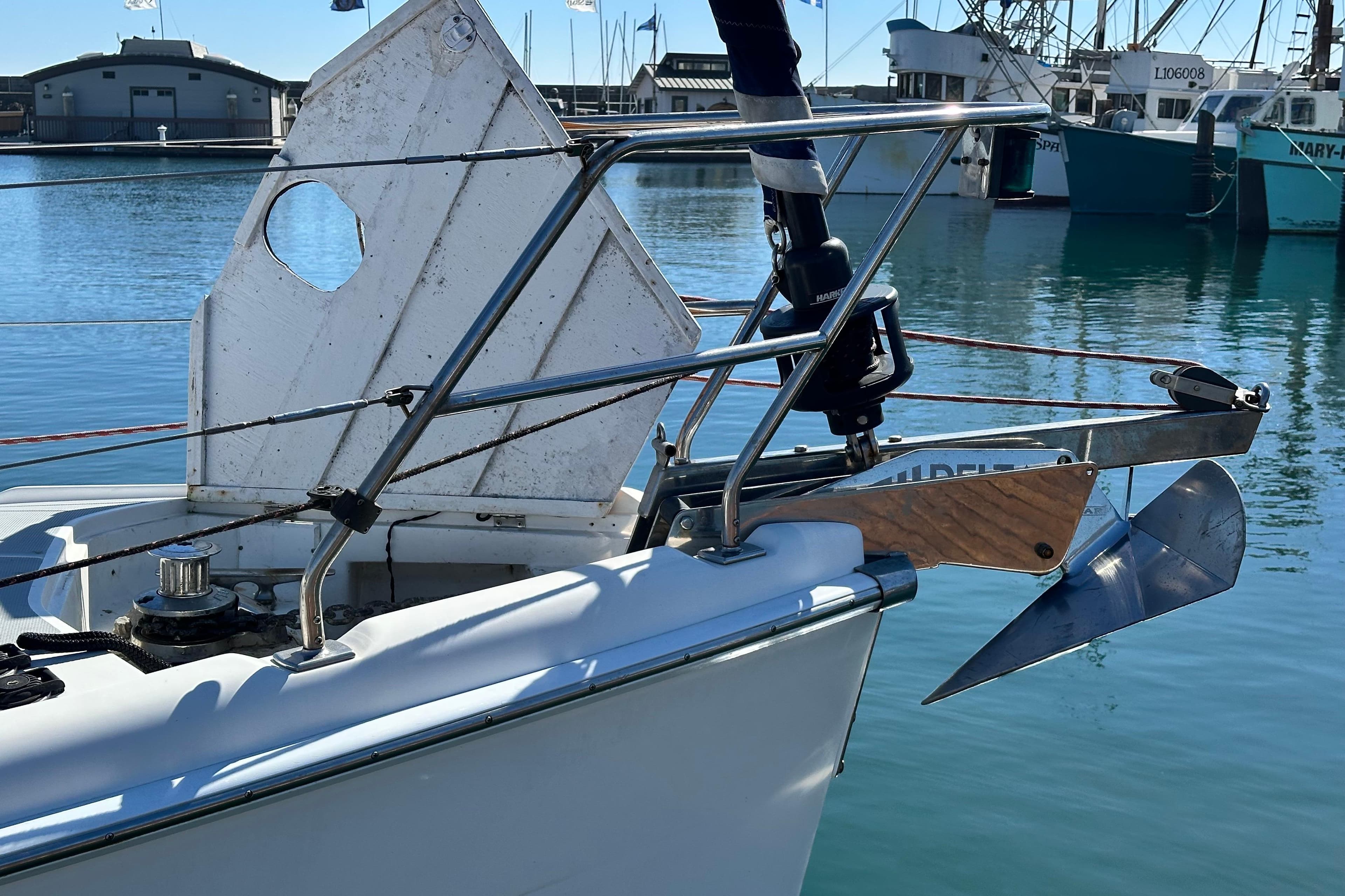 Bow of 2005 Hunter 41 AC sailboat with anchor in marina setting.