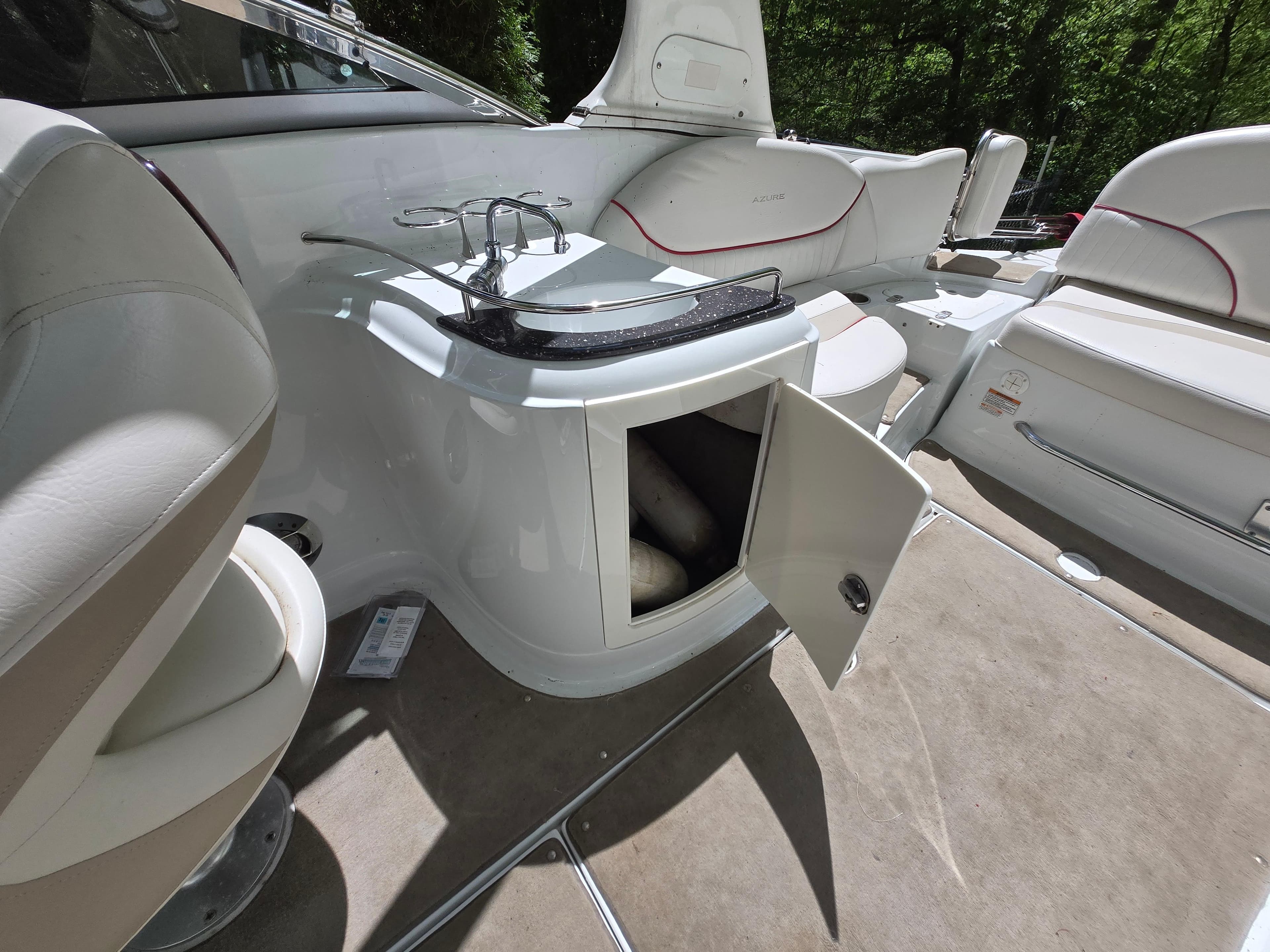 2009 Azure AZ298 boat interior with open storage, sink, and seating.