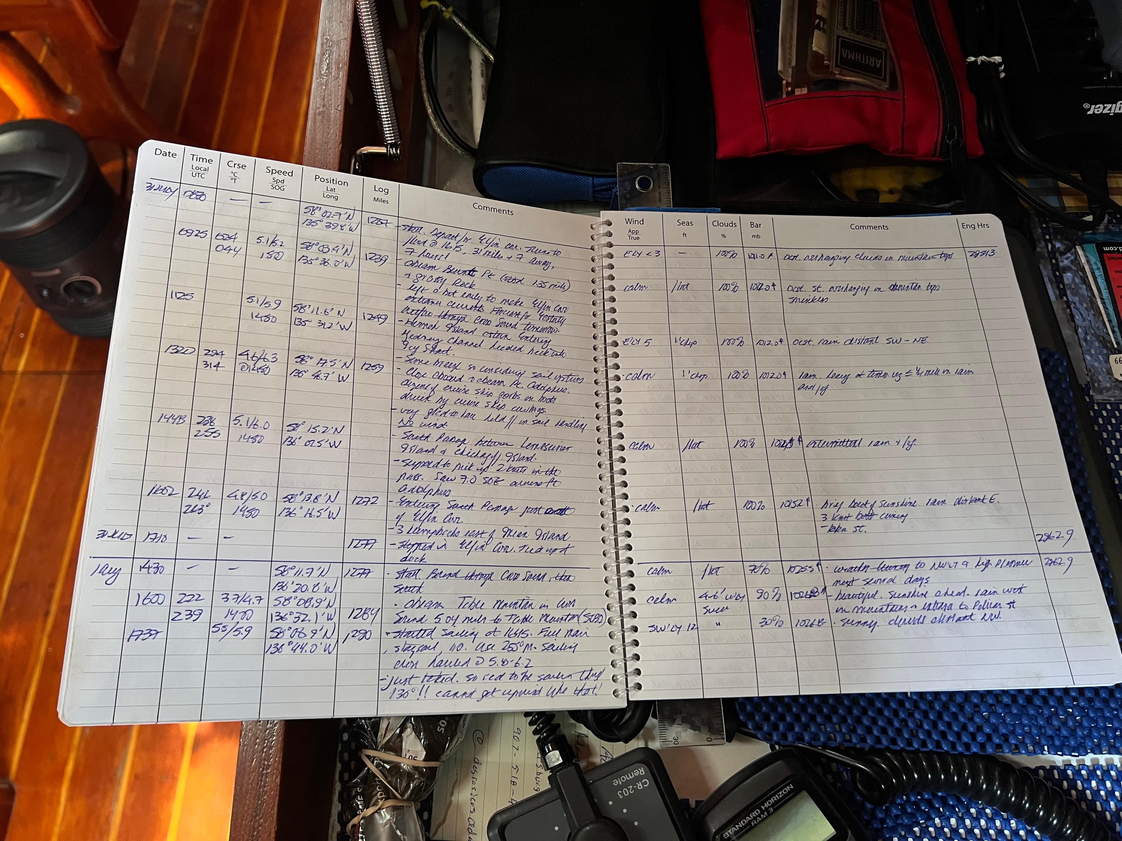 Open notebook with handwritten notes on a Reliance 45, 1987 model, in a nautical setting.