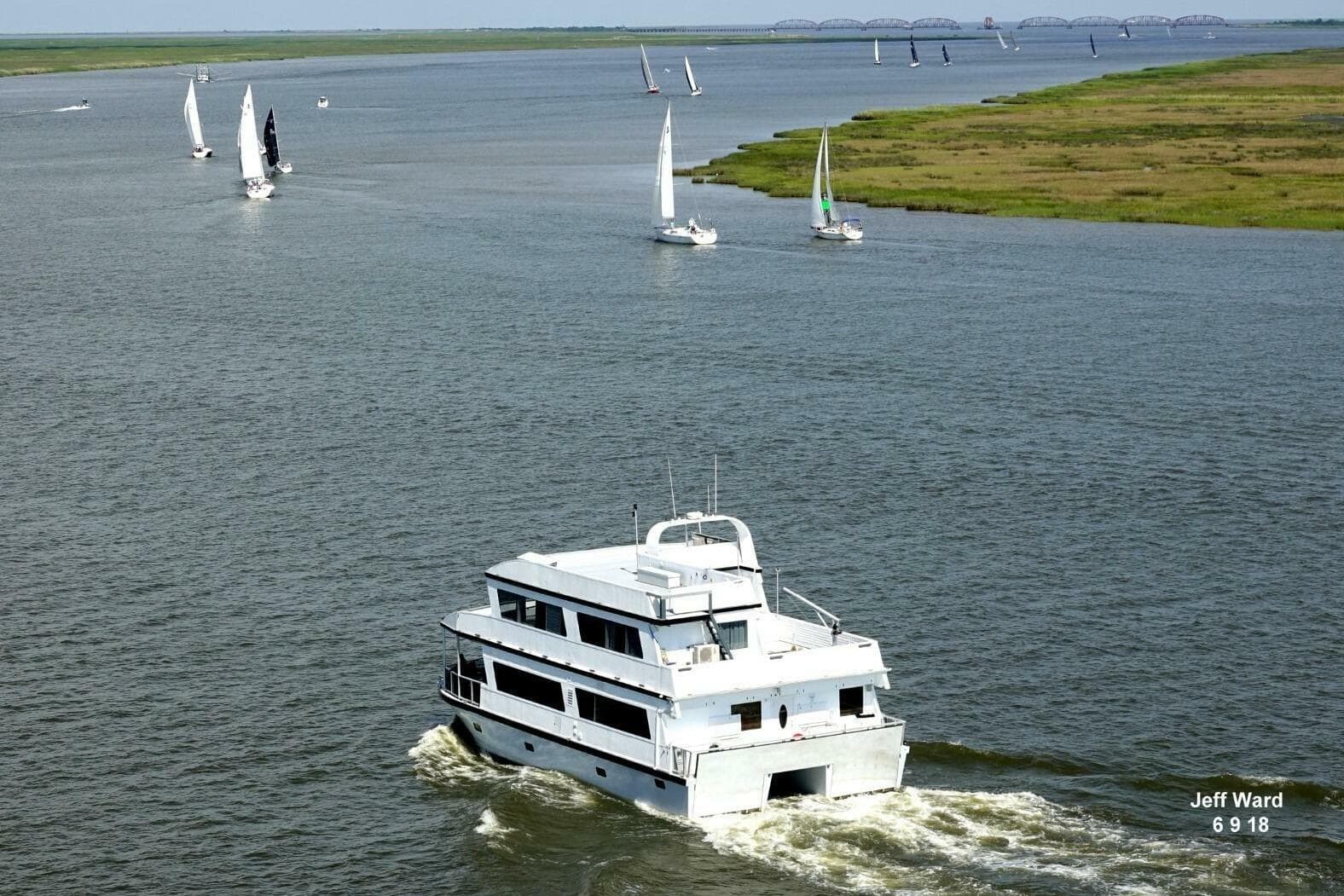 2018 Avenger Custom Luxury Catamaran cruising coastal waters with sailboats nearby.