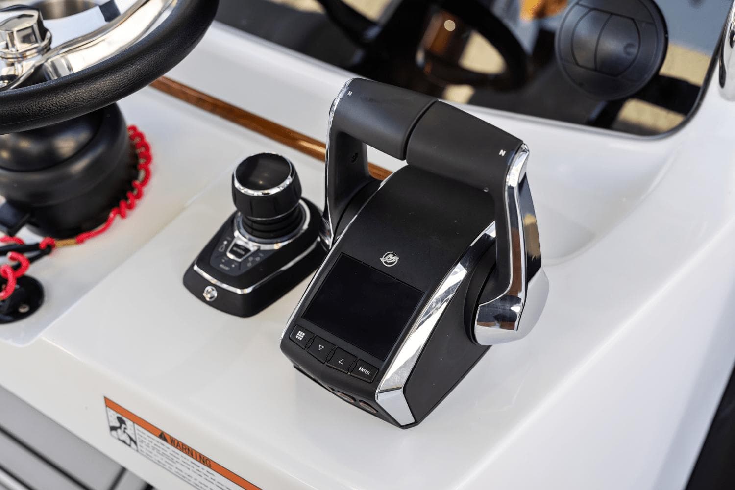 Close-up of the 2024 Aquila 47 Molokai boat's control panel and throttle.