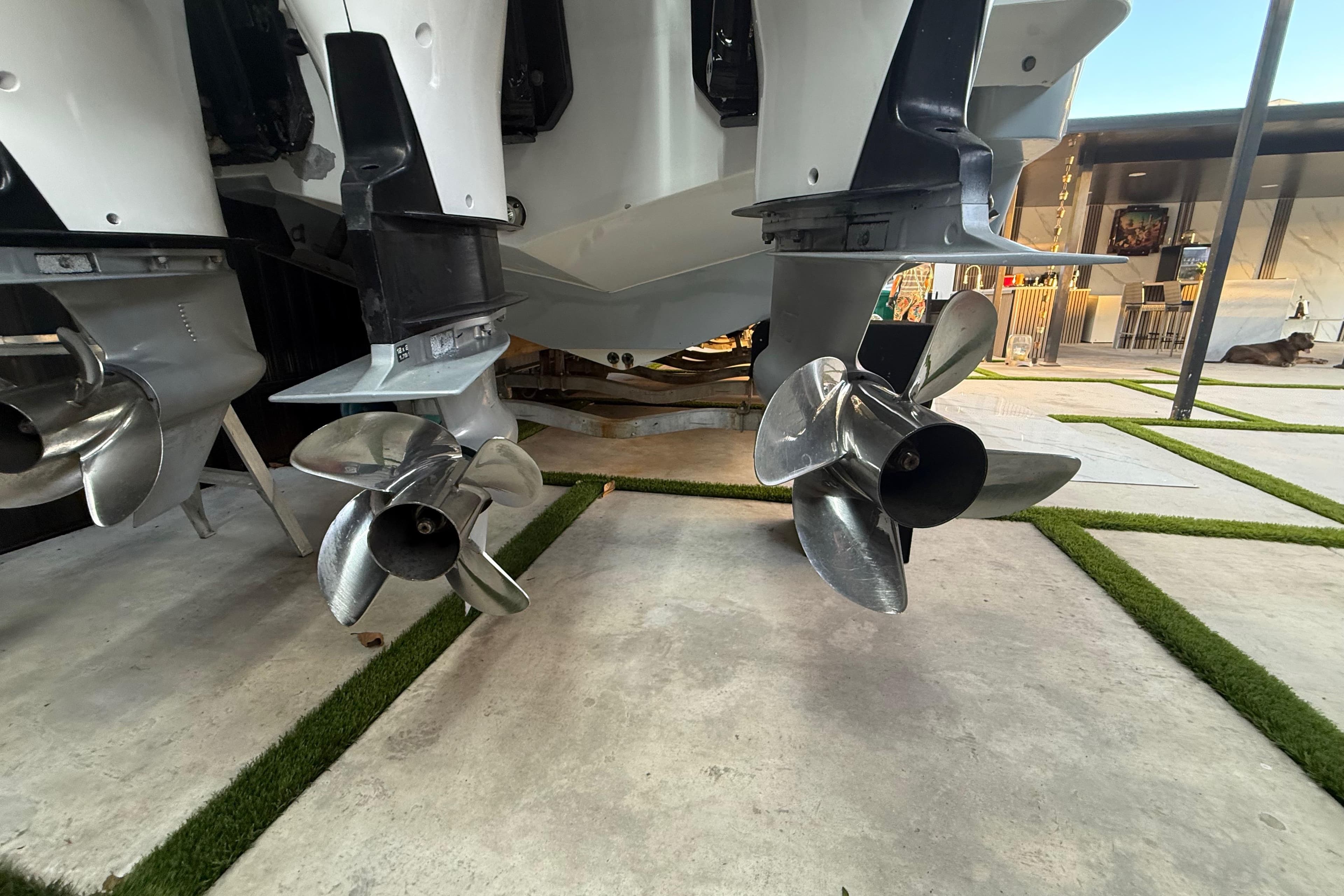 Propellers of a 2005 Formula 330 Sun Sport boat on display in a modern setting.
