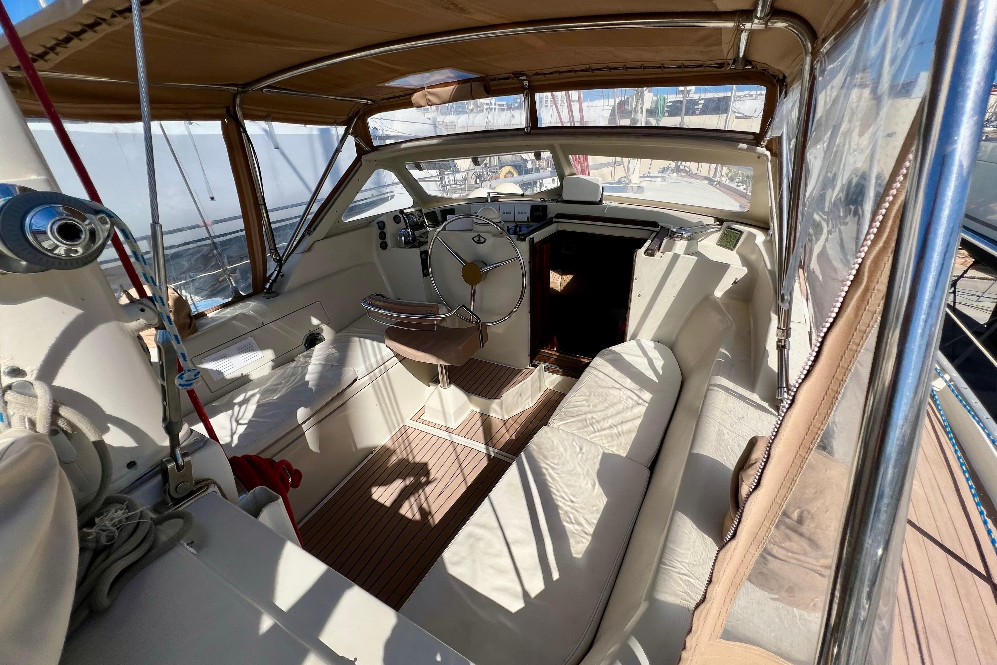1995 Amel Santorin 46 yacht cockpit with steering wheel and seating area.