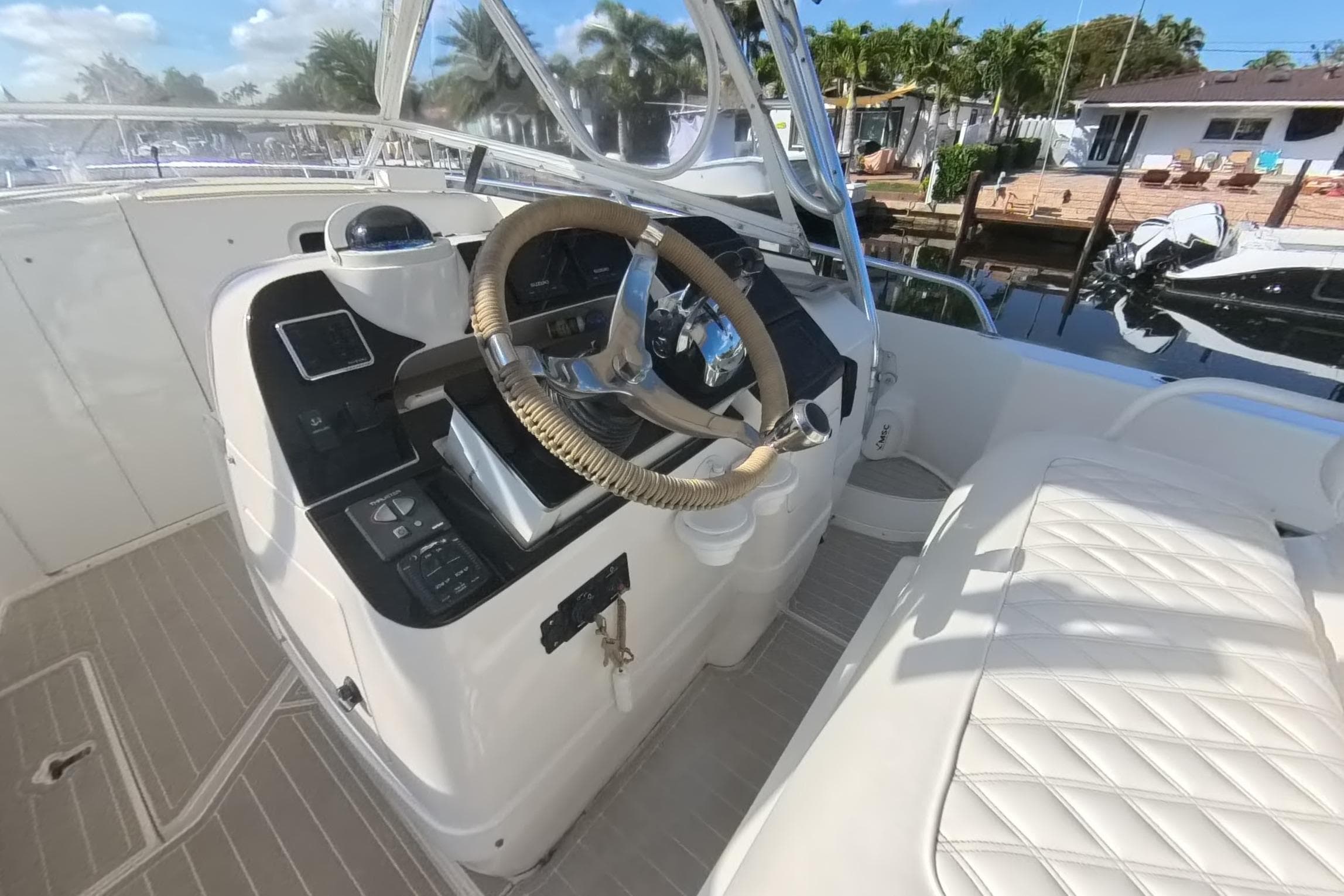2005 Intrepid 348 Walkaround boat helm with steering wheel and control panel.