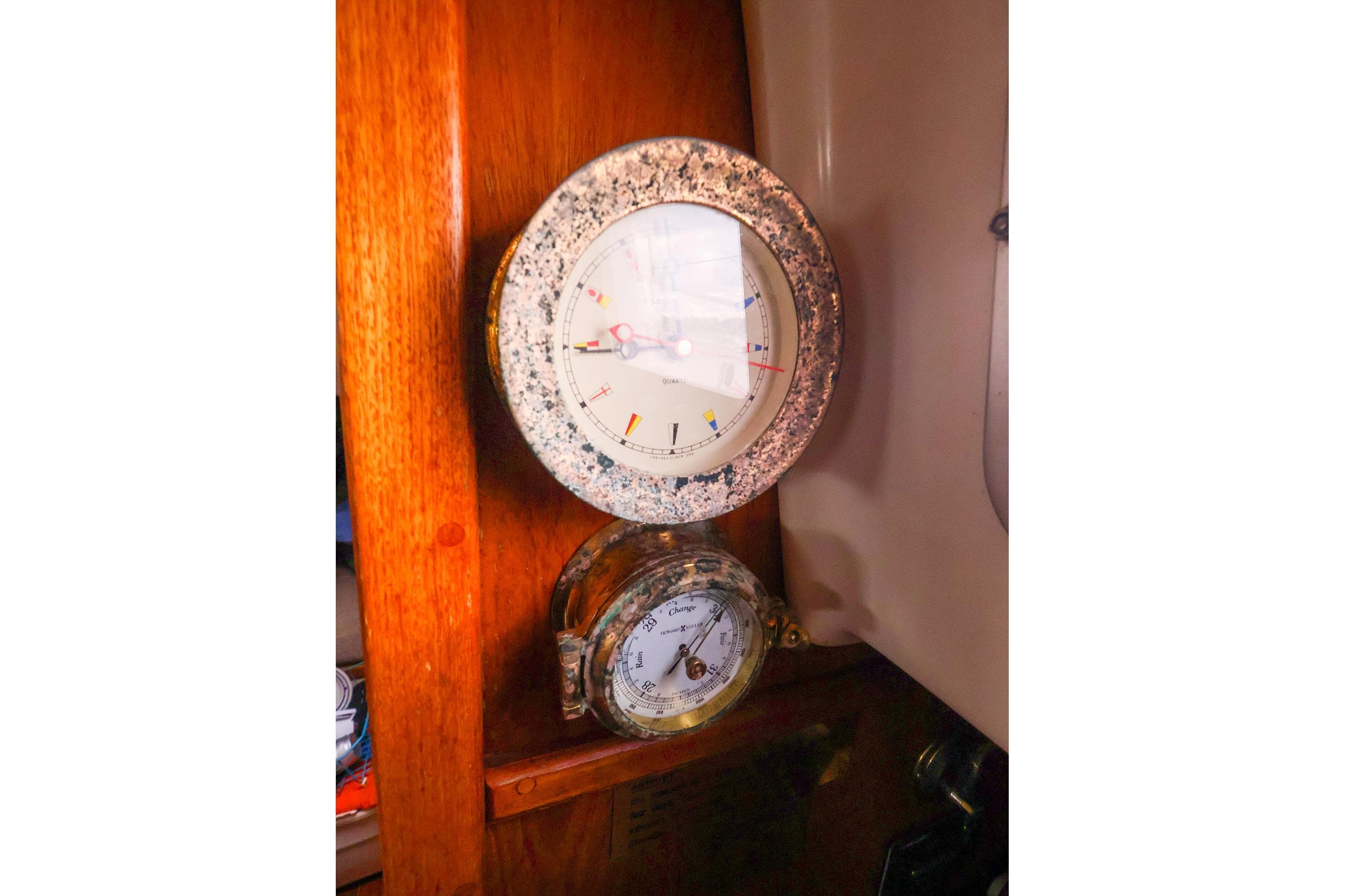 Vintage nautical instruments on 1985 Bayfield 40 yacht, featuring a clock and barometer.