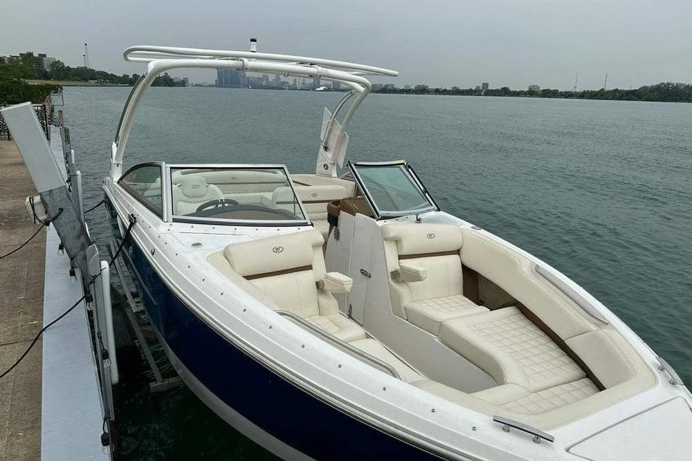 2020 Cobalt R7 boat docked by a serene waterfront, featuring luxurious white seating.