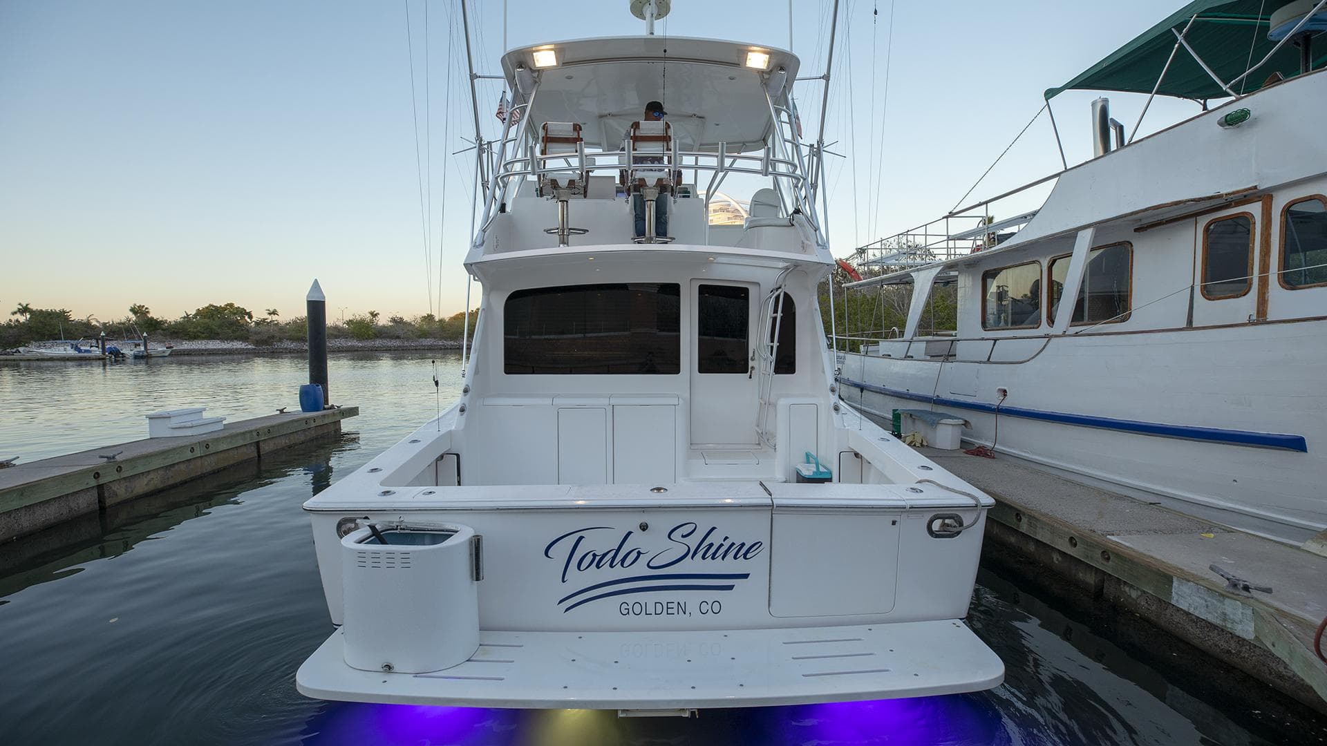 2007 Viking 45 Convertible yacht docked with illuminated underwater lights.