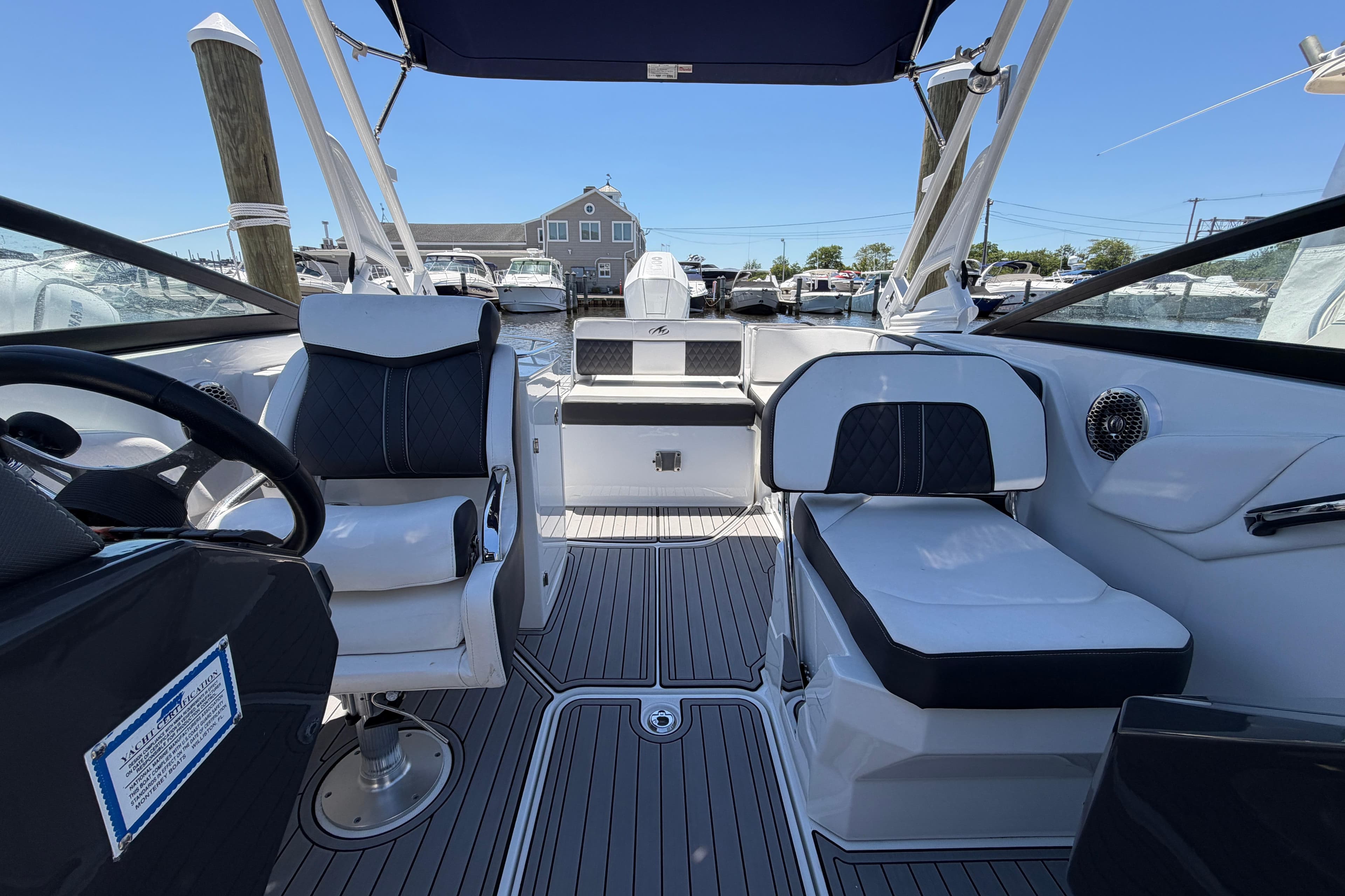 Interior of a 2023 Monterey M-65 boat with modern seating and steering wheel.