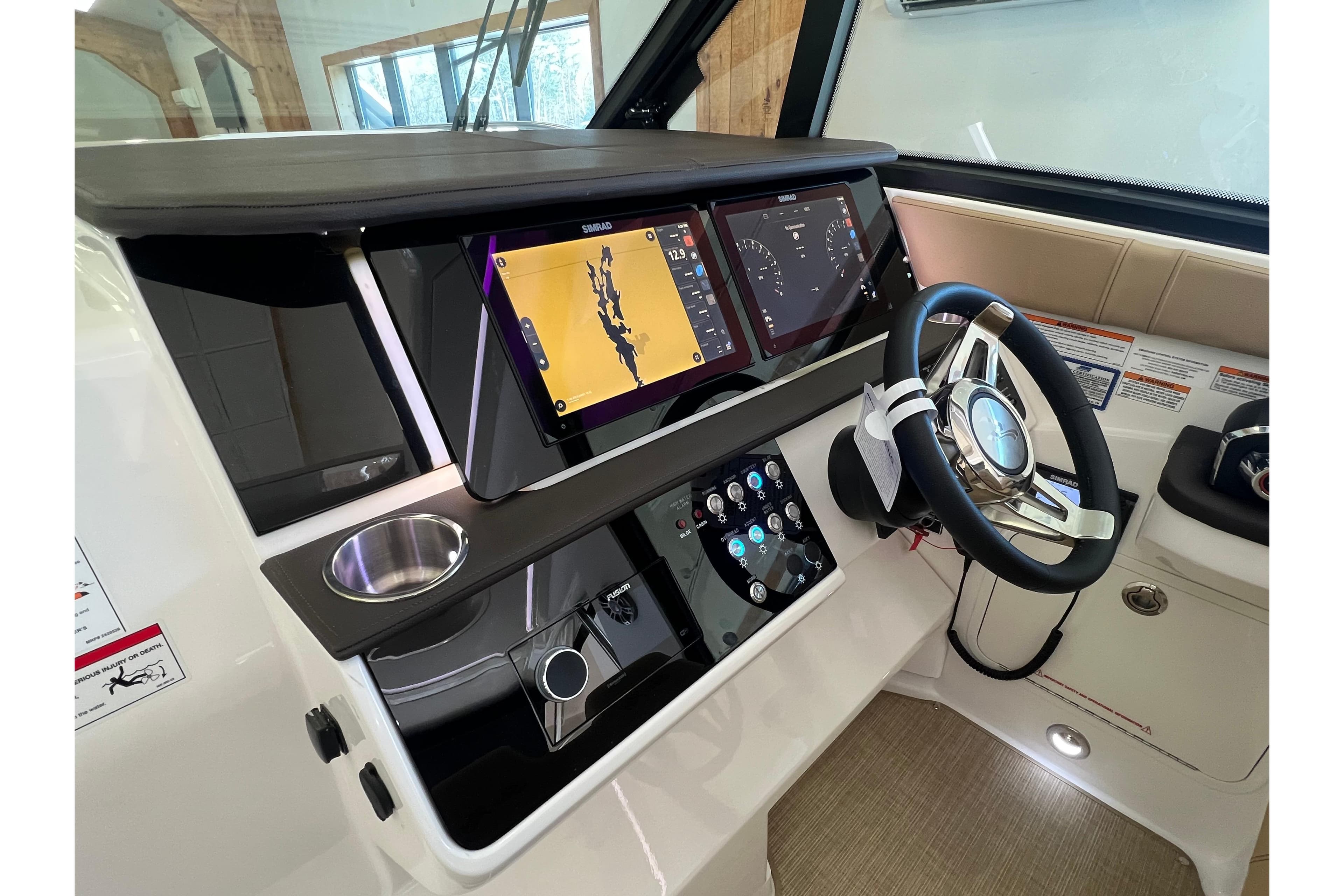 2024 Sea Ray Sundancer 320 helm with advanced navigation displays and modern steering wheel.