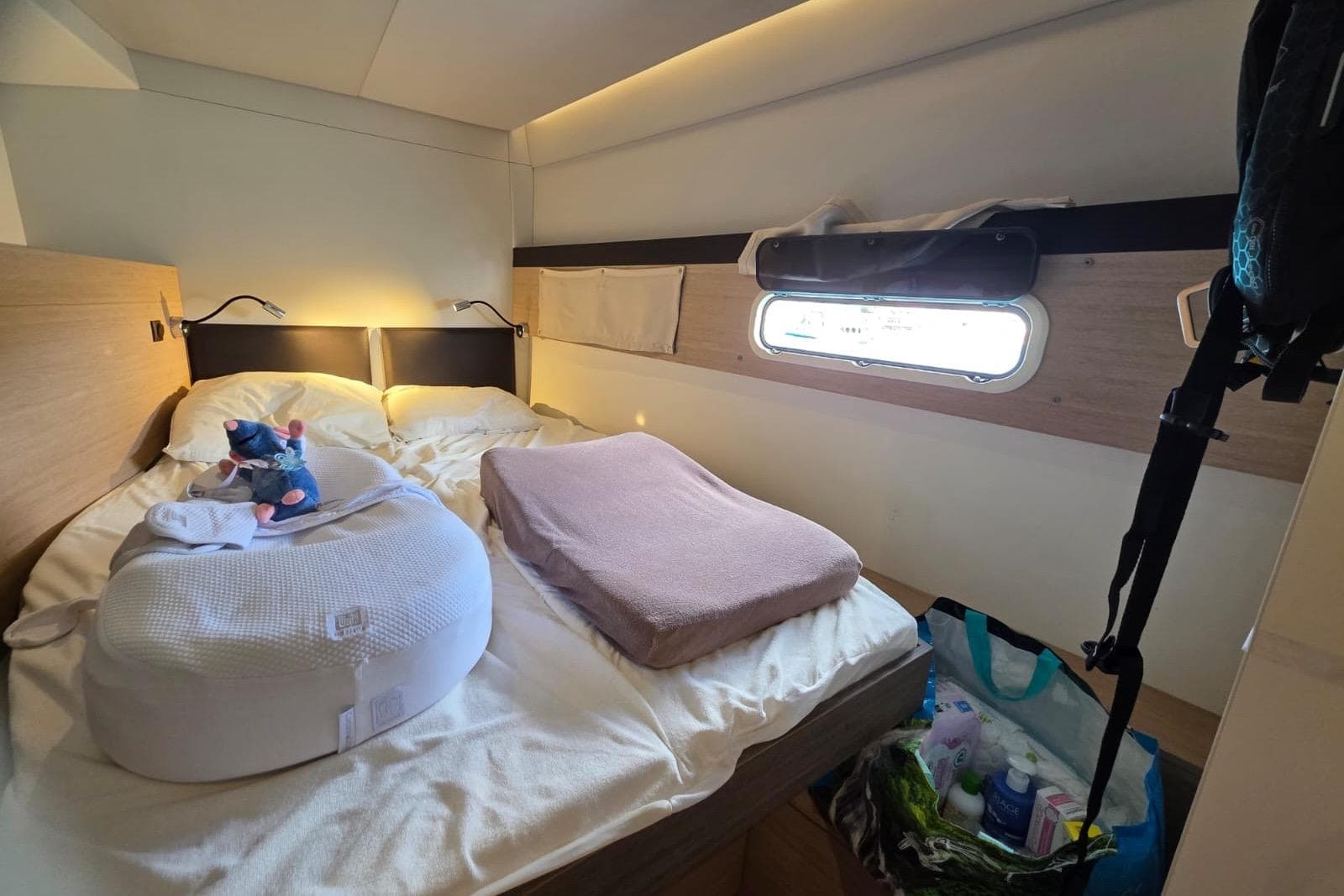 Cozy cabin interior of a 2016 Bali 4.5 yacht with bed and window view.