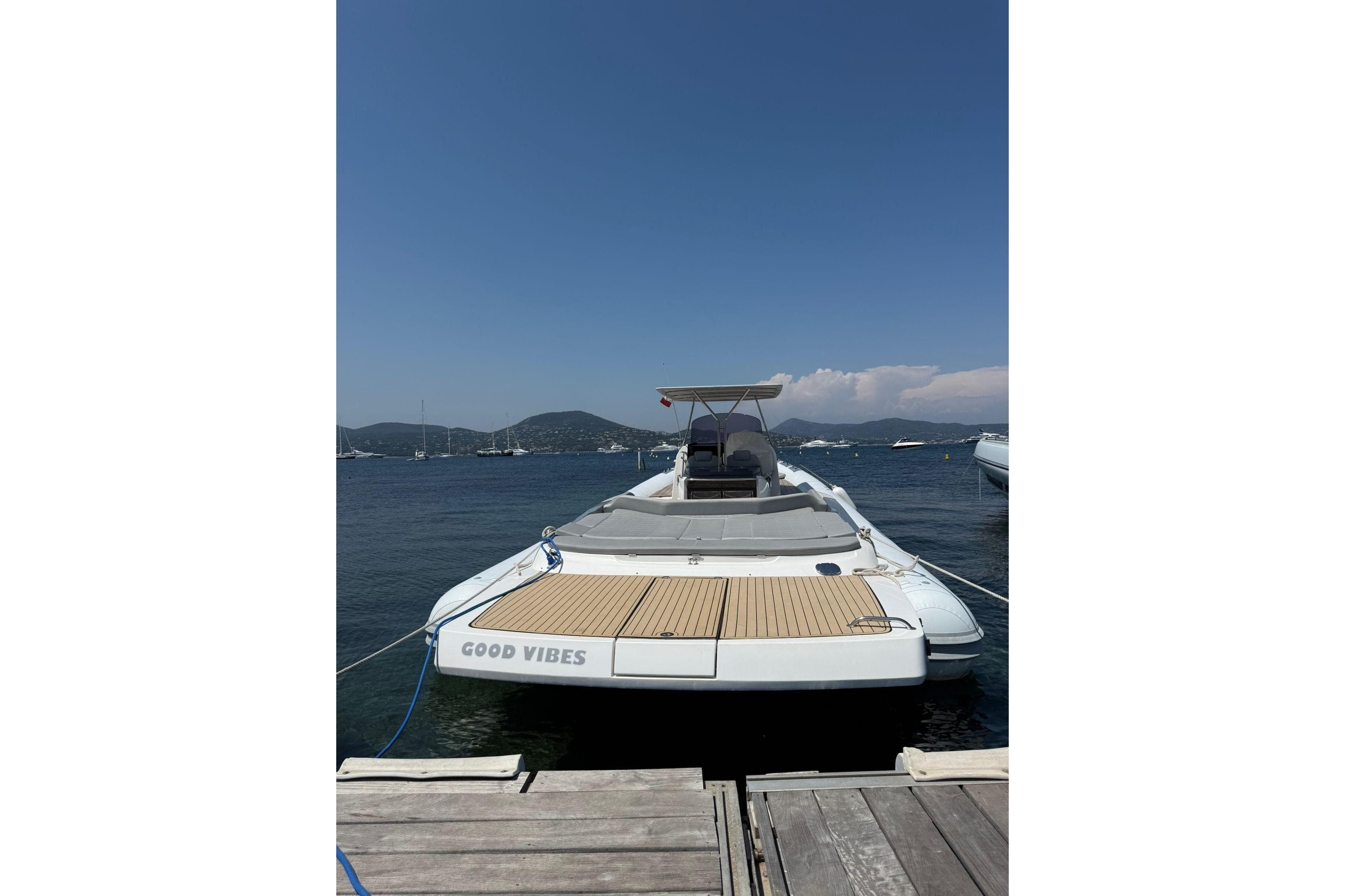 SACS Strider 13 boat docked, rear view, with "Good Vibes" text, 2011 model.