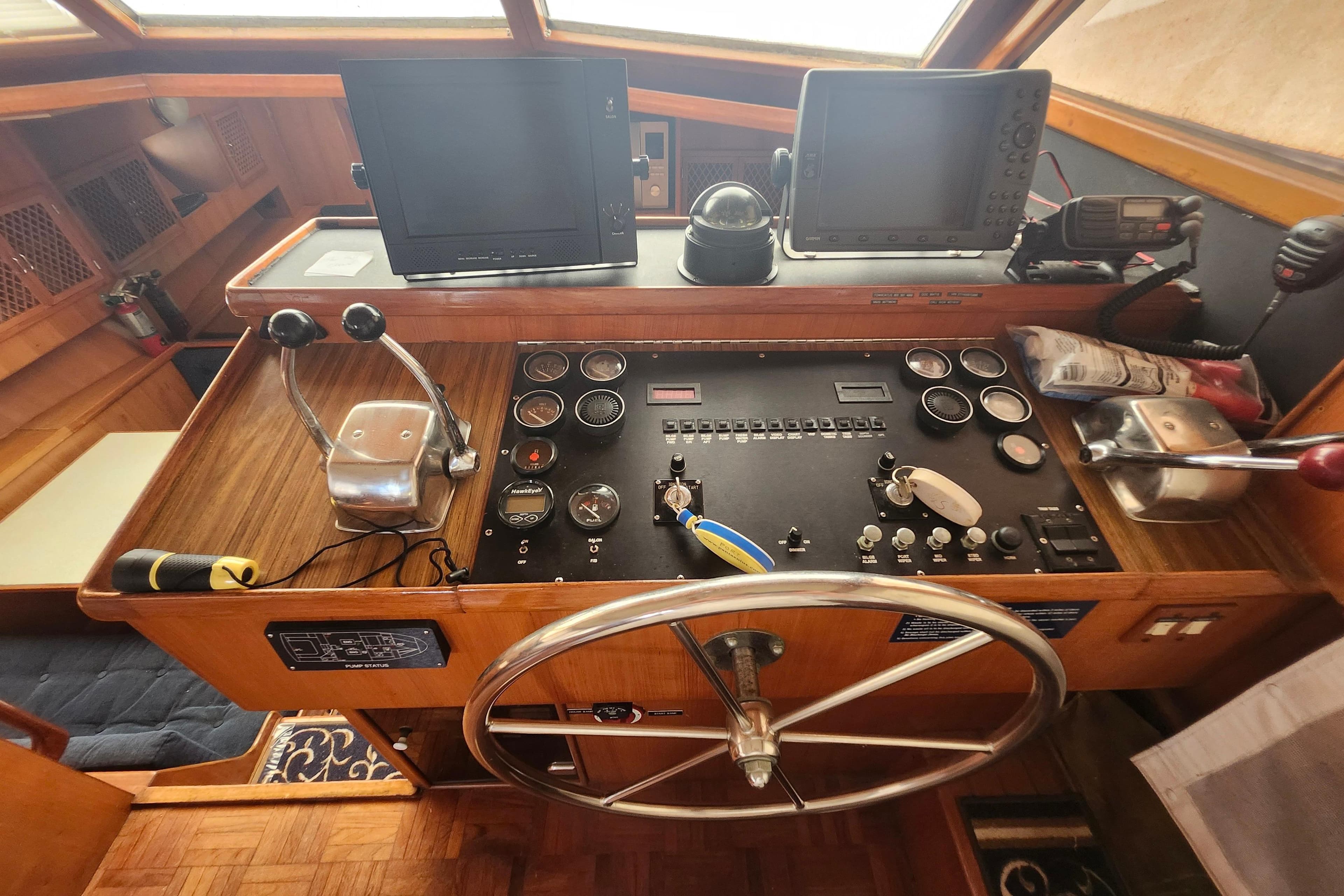 1988 Marine Trader 43 helm with navigation equipment and steering wheel.