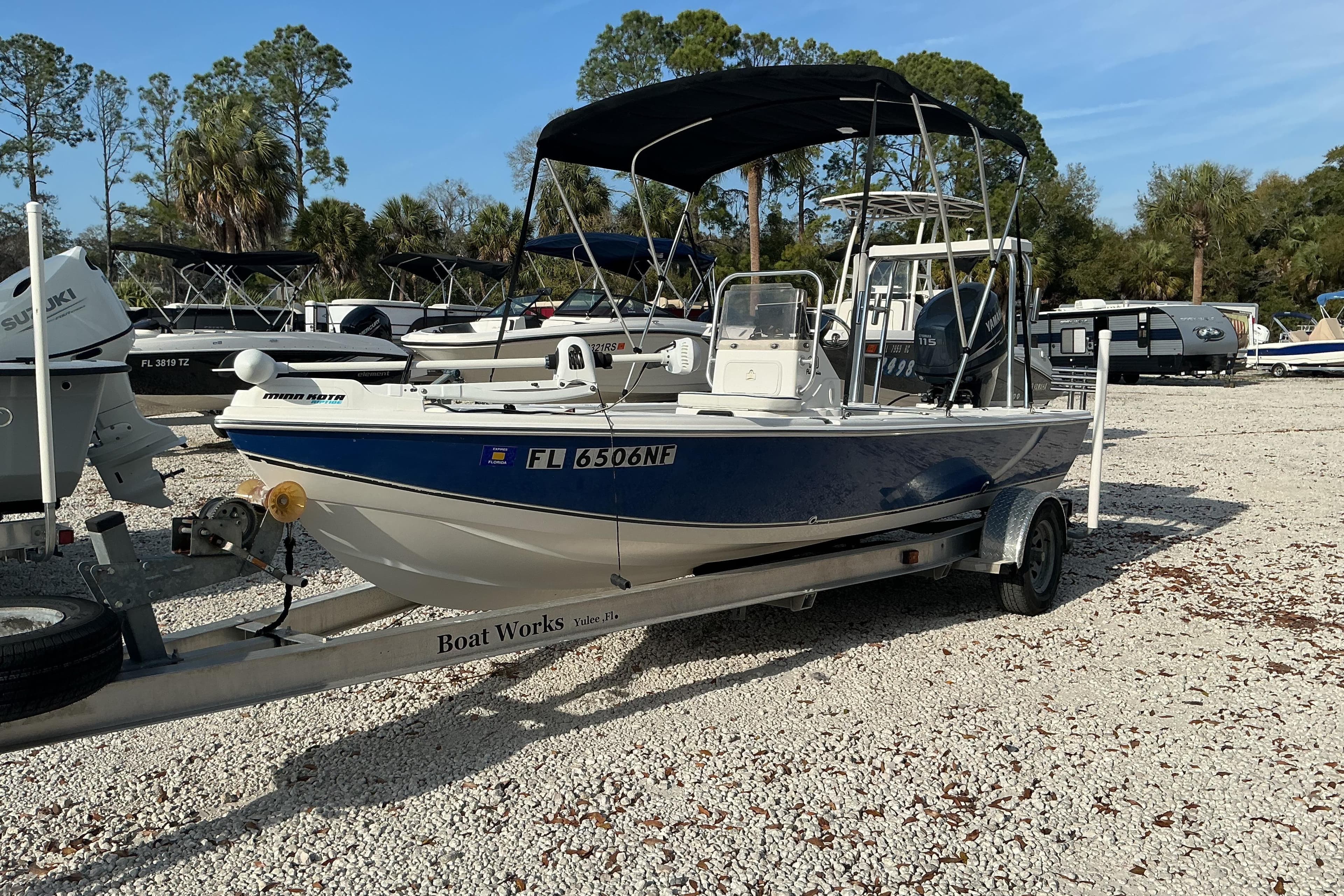 2007 Sea Chaser 180 Flats boat on trailer, parked in a lot with other boats.
