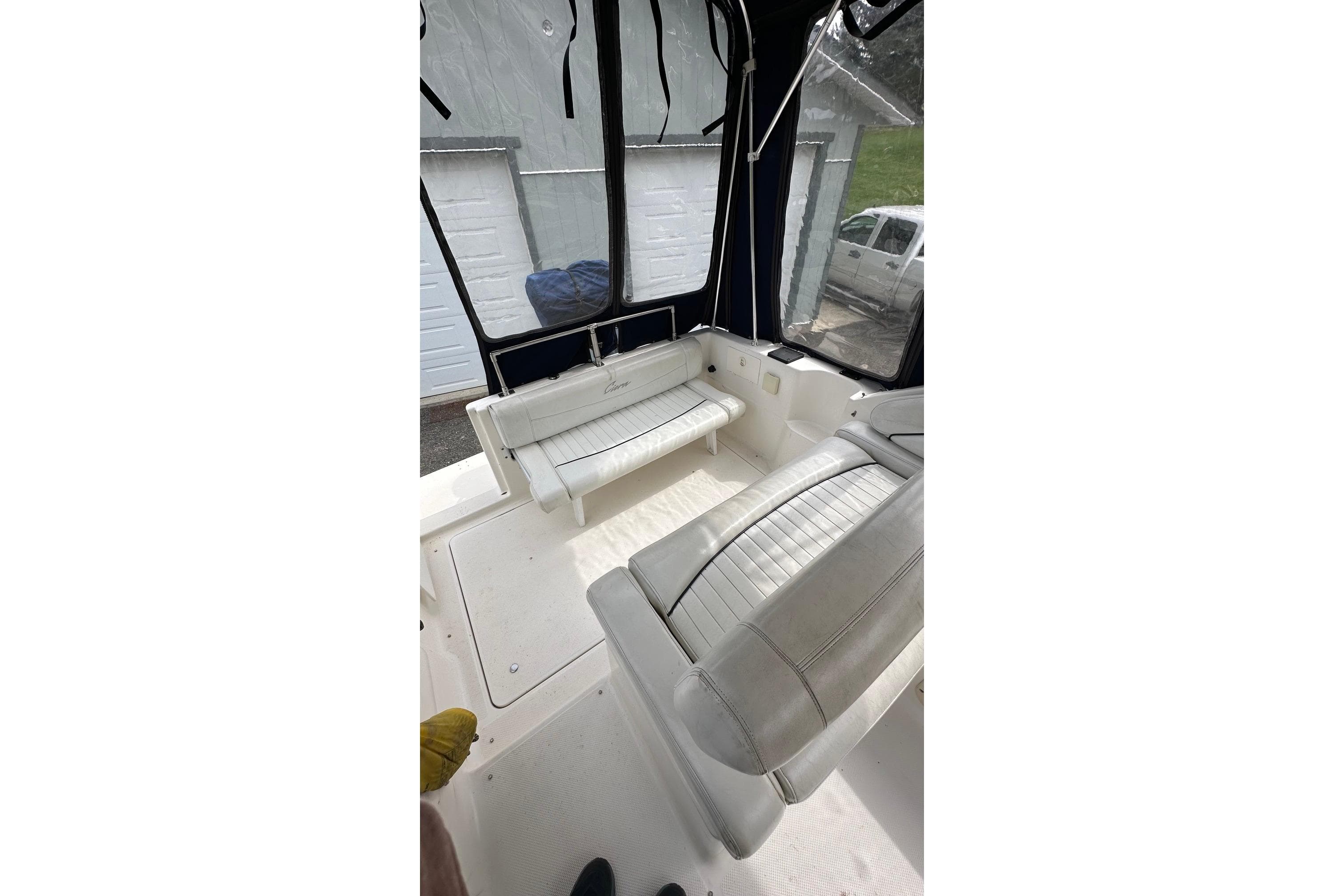Interior of a 1997 Bayliner 2655 Ciera Sunbridge boat with white seating.
