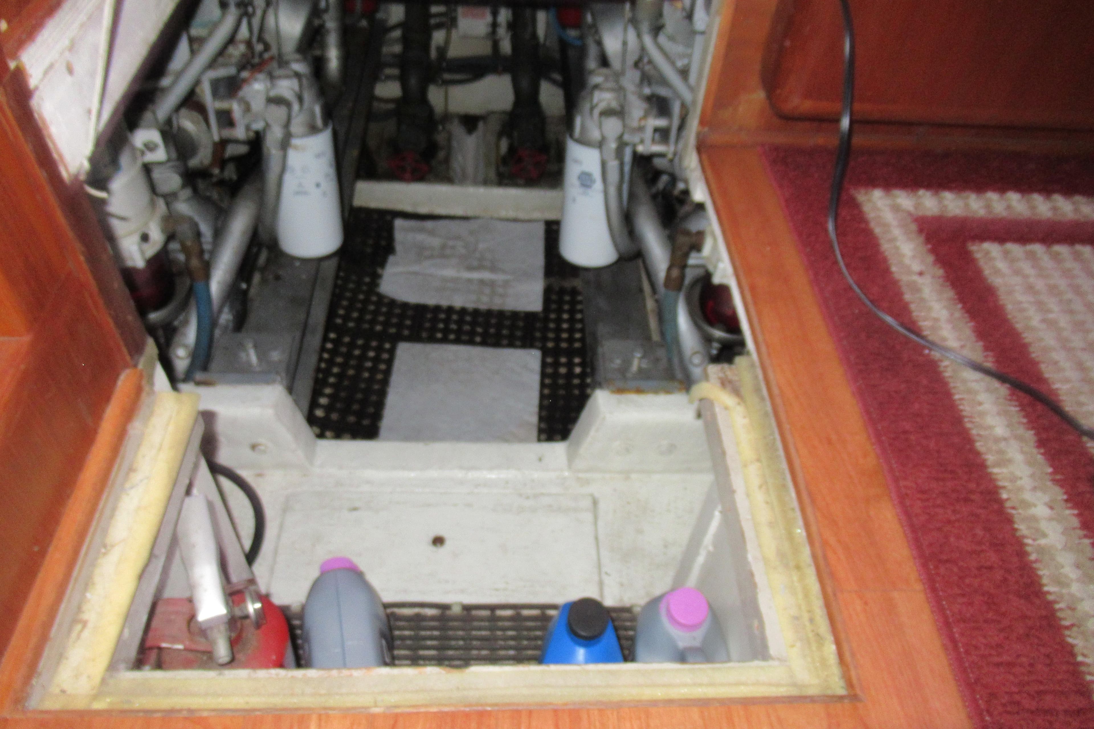 Engine compartment of a 1990 Viking 38 Convertible boat, showing maintenance supplies.