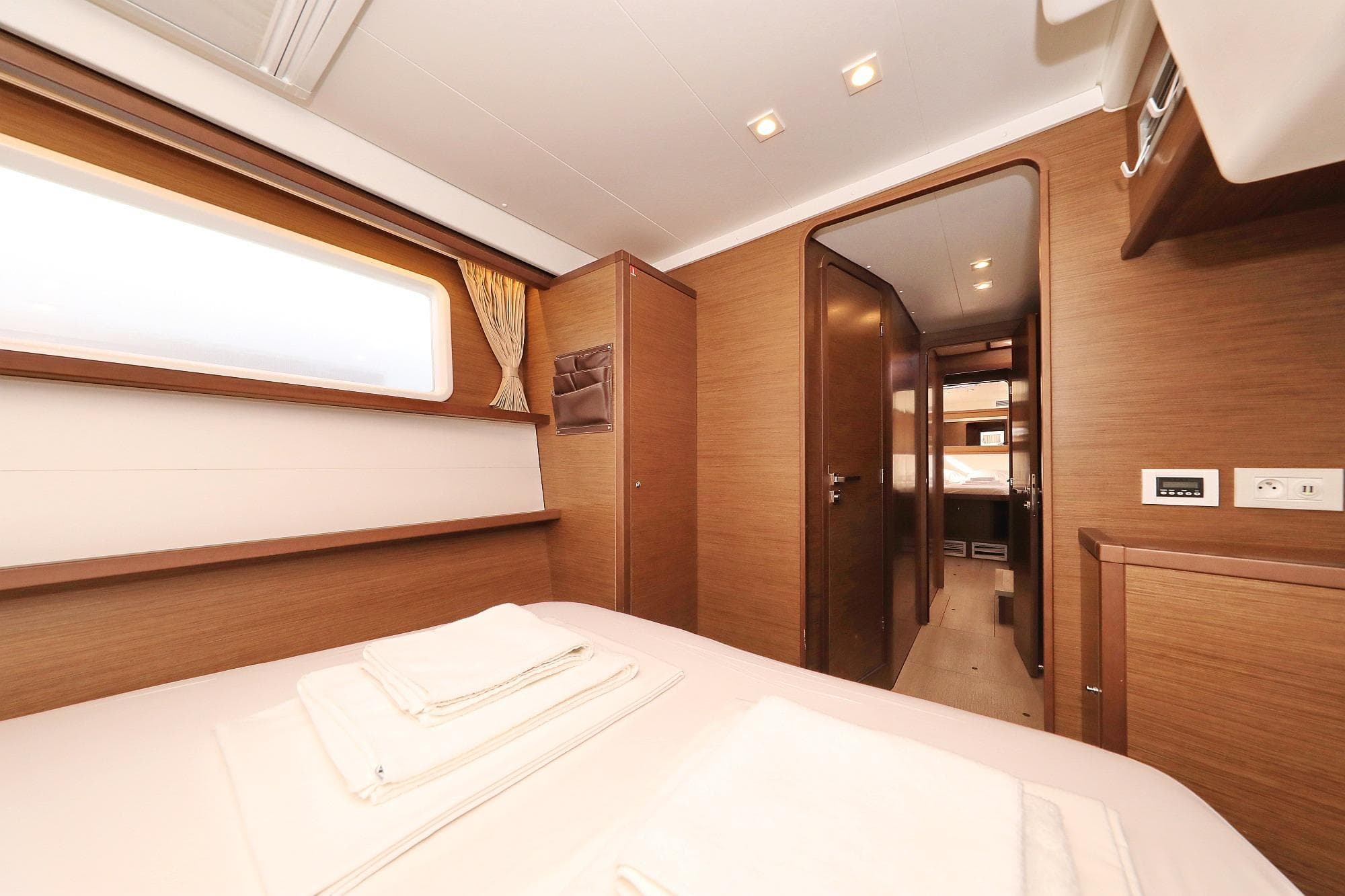 Luxurious interior of 2018 Lagoon 450 F catamaran cabin with modern wood finish.