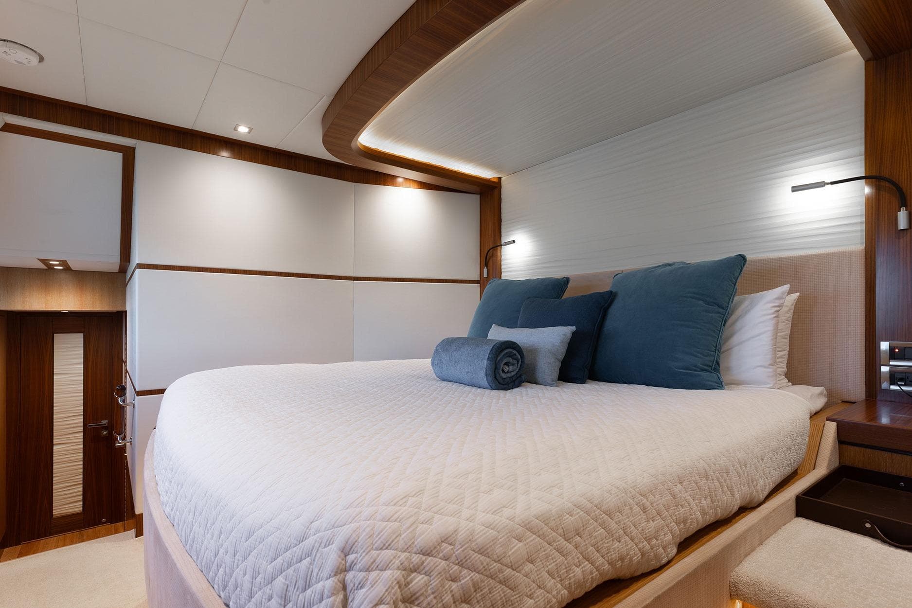 Luxurious bedroom interior on 2018 Horizon PC74 yacht with elegant bedding and ambient lighting.