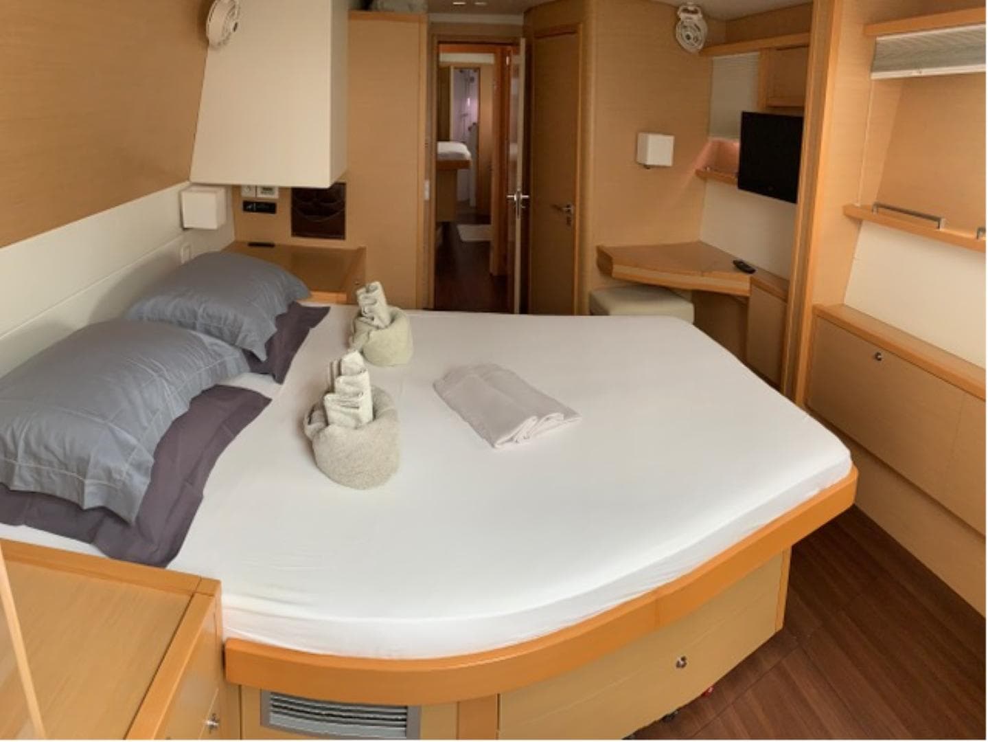 Luxurious cabin interior of a 2012 Lagoon 560 yacht with a neatly made bed.
