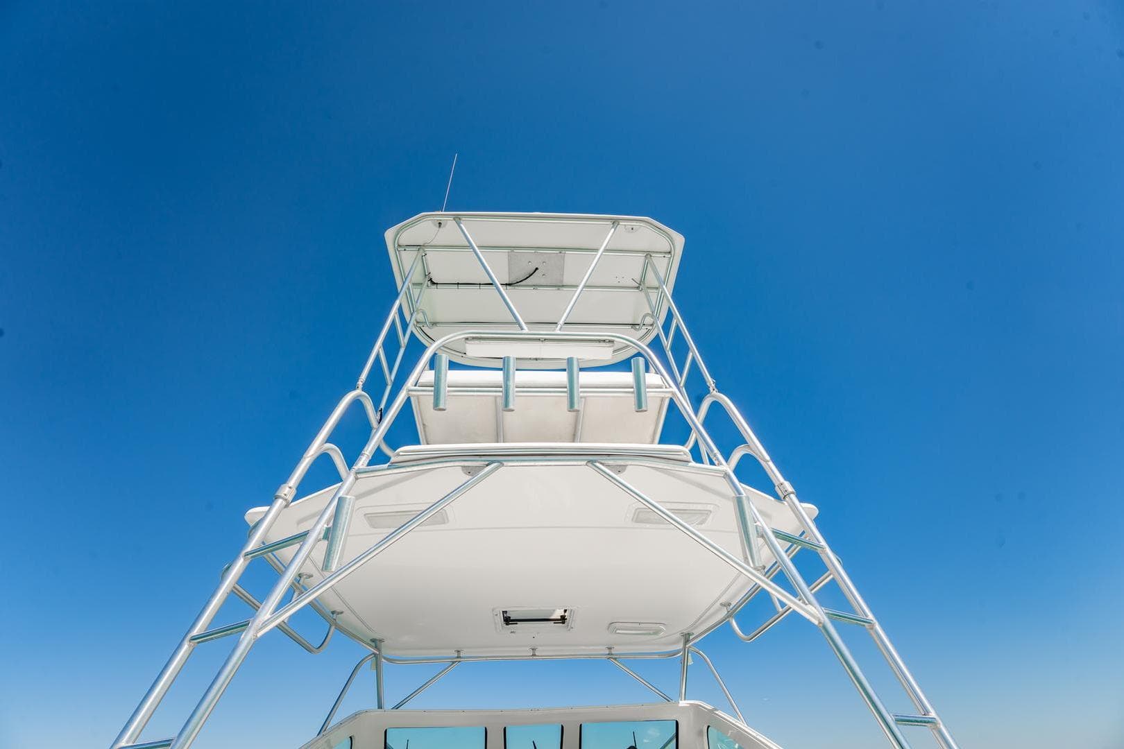2004 Luhrs Tournament 320 Open boat tower against clear blue sky.