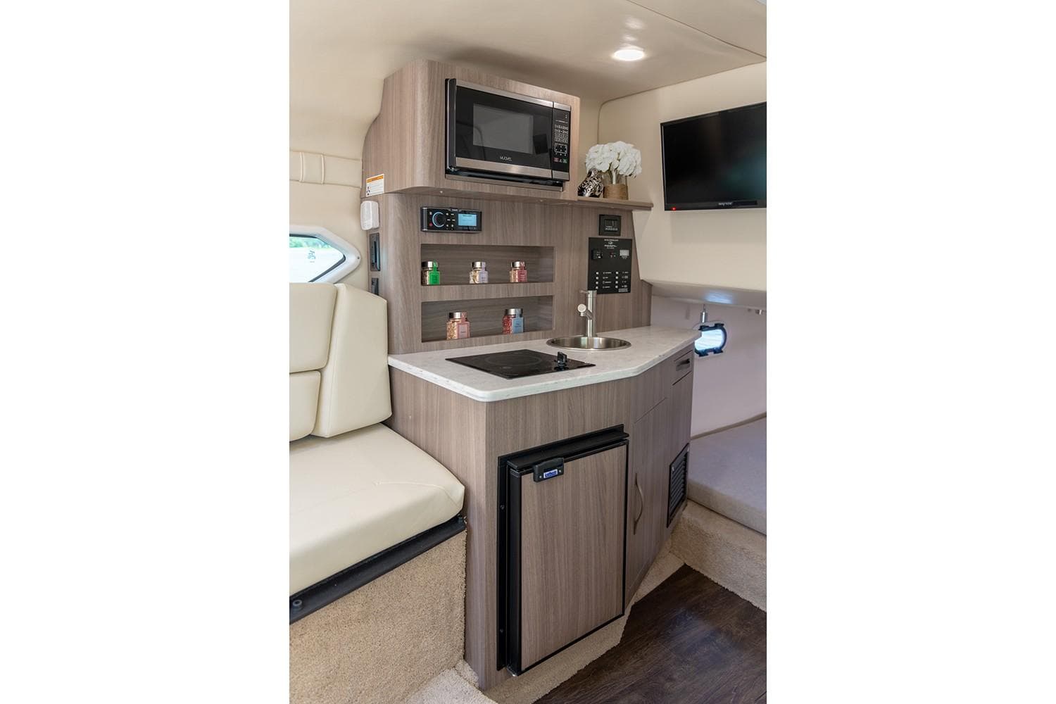 Manufacturer Provided Image: 2022 Regal 26 XO boat interior kitchen with microwave, sink, and mini-fridge.
