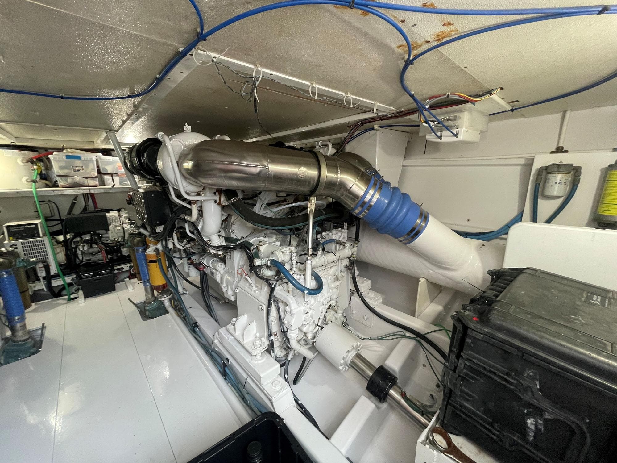 Engine room of 2001 Custom Carolina Lydia 57 Sportfish, showcasing detailed mechanical components.