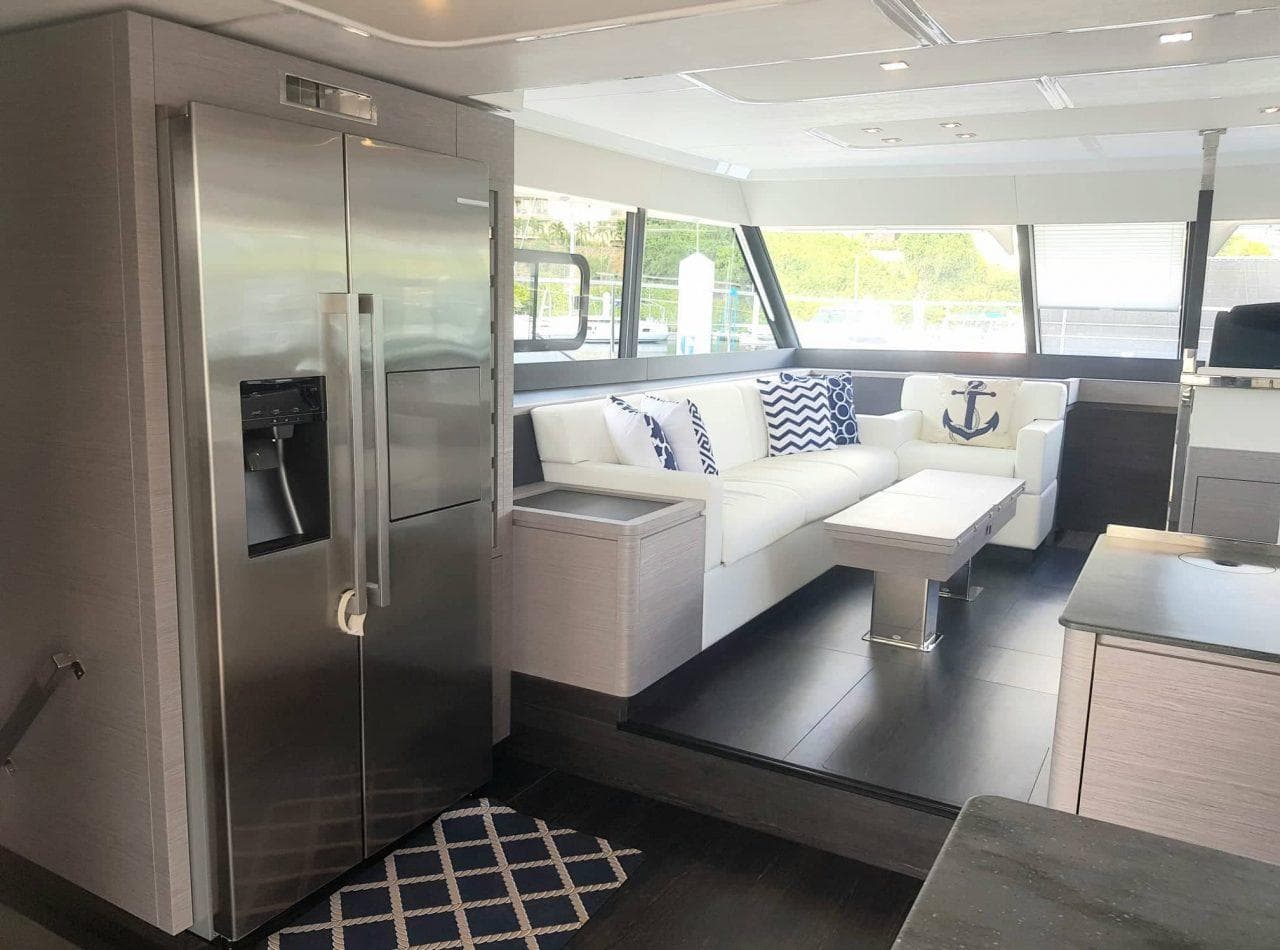 Luxurious interior of 2021 Fountaine Pajot MY6 yacht with modern kitchen and stylish seating area.