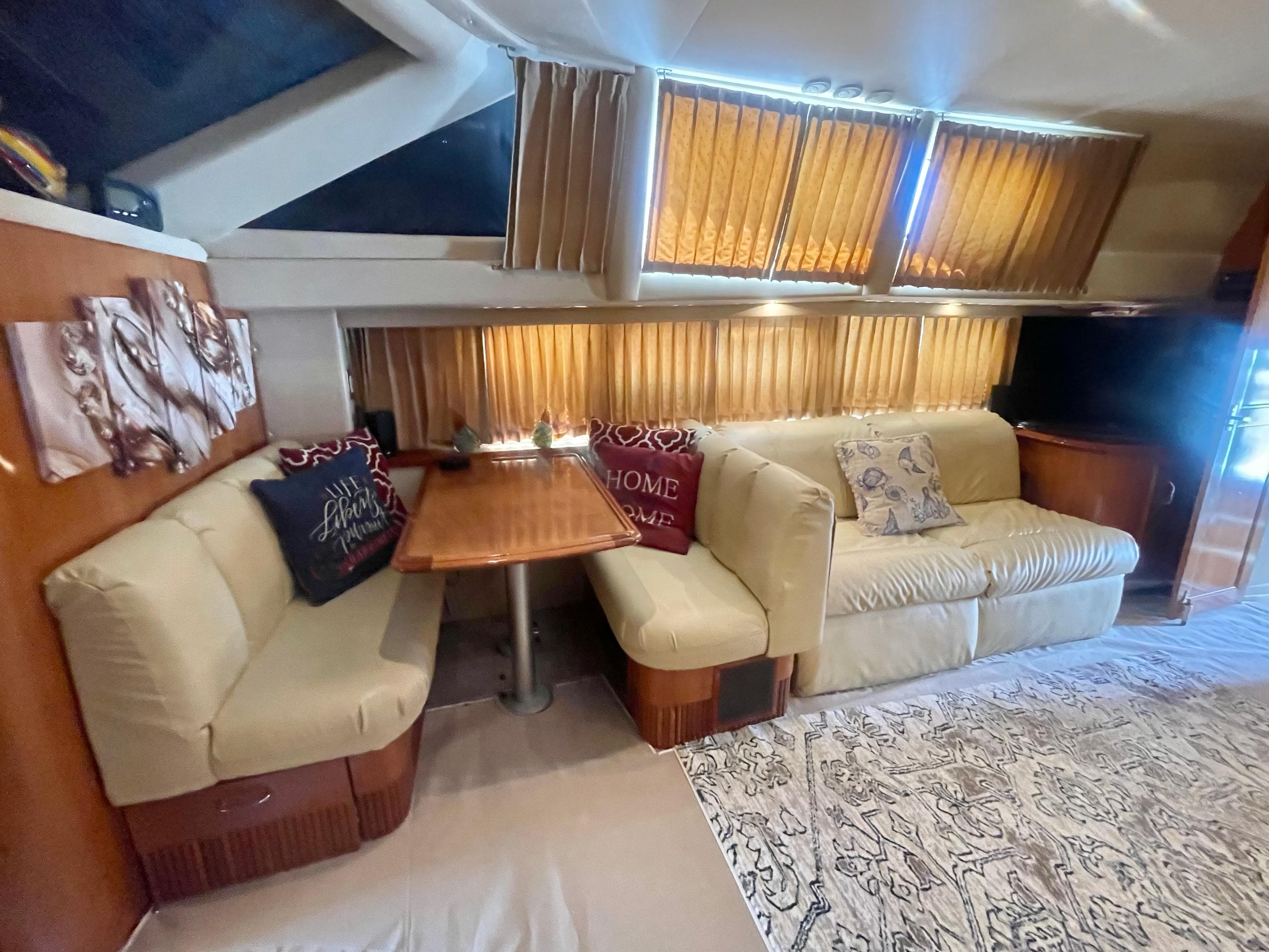 Interior of 2004 Carver 44 Cockpit Motor Yacht with cozy seating and dining area.