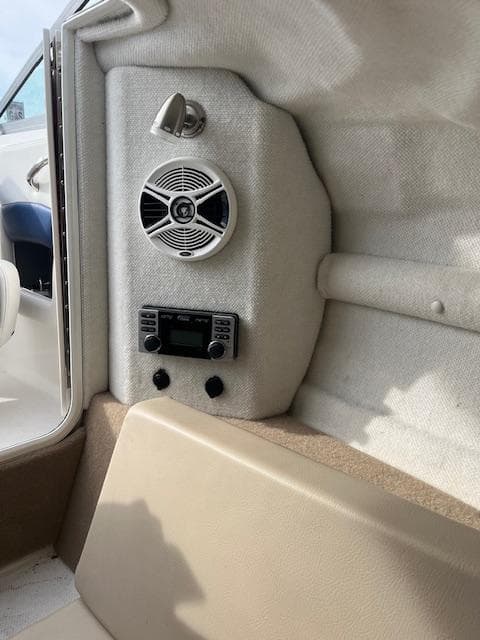 Interior of 2013 Chaparral 225 SSi boat with speaker and control panel.
