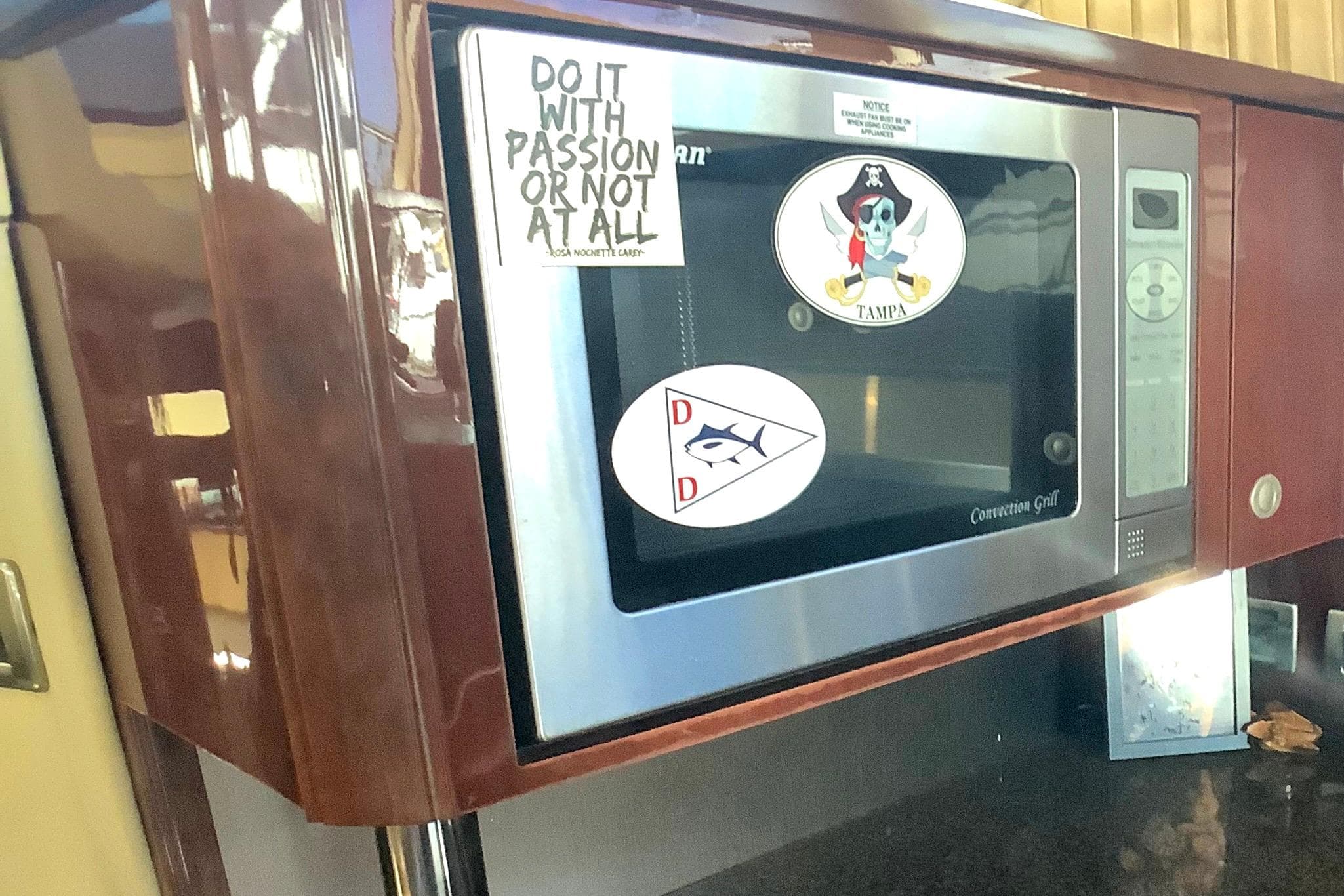 Microwave in 2007 Sea Ray 52 Sedan Bridge with decorative stickers.