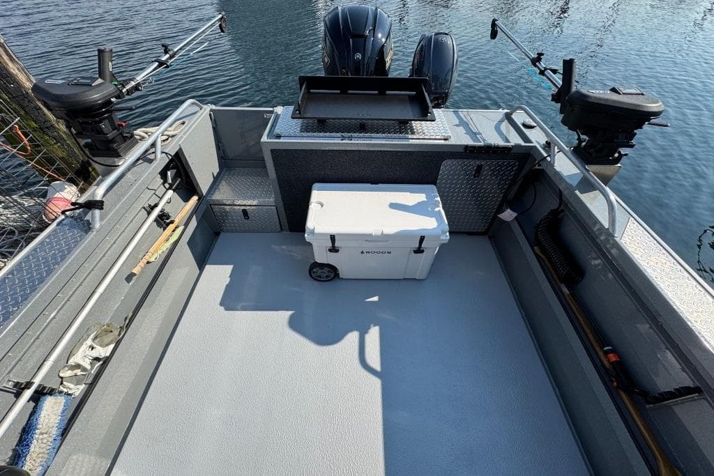 2023 Boulton VOYAGER PRO boat deck with fishing gear and cooler.