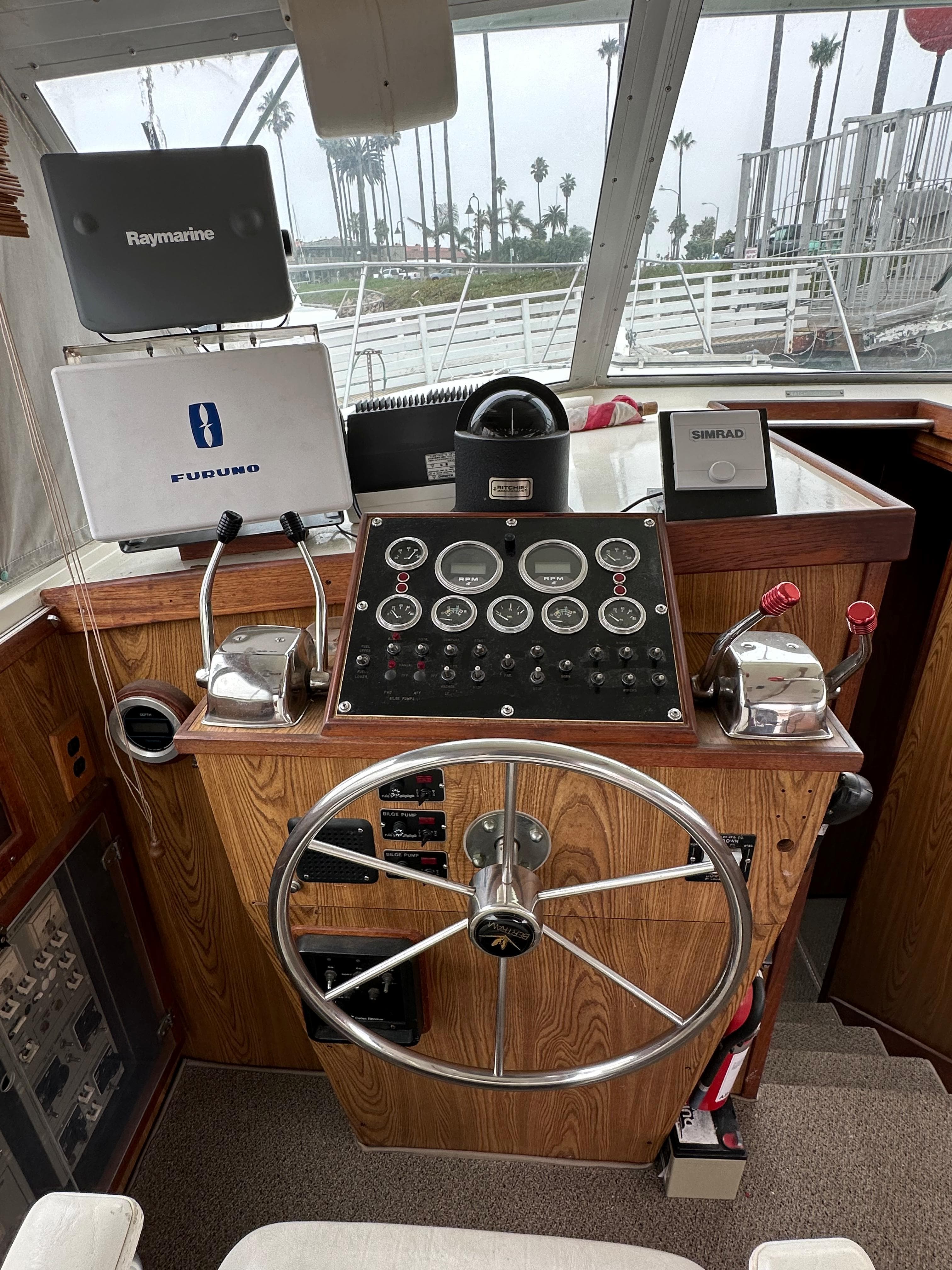 1981 Bertram 38III Convertible boat helm with navigation equipment and steering wheel.