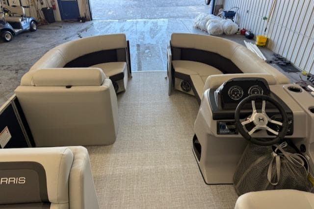 Interior of a 2025 Harris CR190 boat with beige seating and modern dashboard.