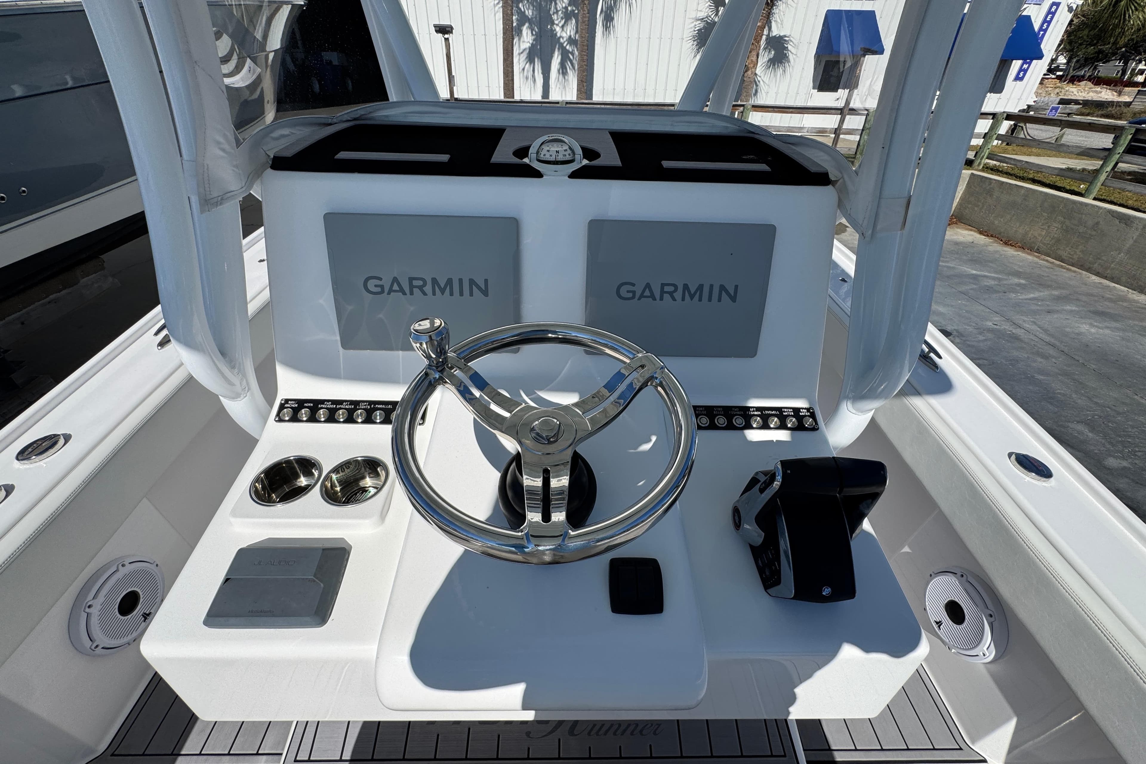 2022 Front Runner 26 Center Console boat dashboard with Garmin displays and steering wheel.