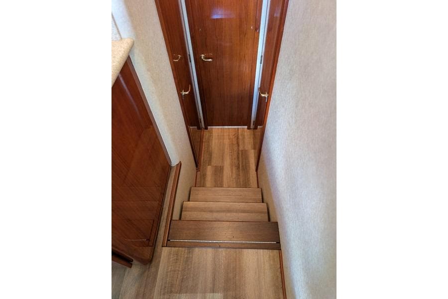 Staircase inside 2005 Egg Harbor 43 SportYacht with wooden finish and elegant design.
