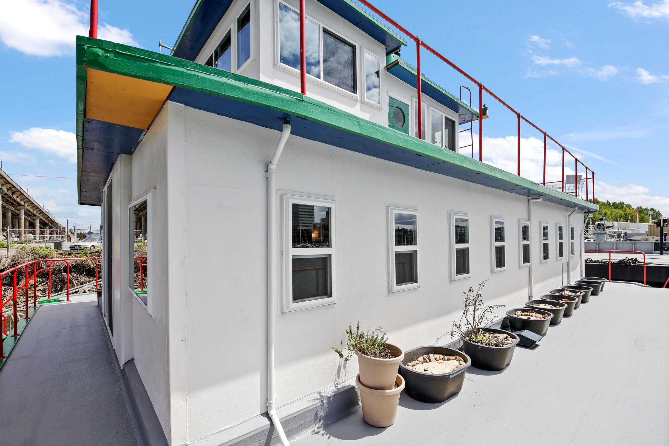 1938 Custom Ferry with white exterior and potted plants on deck.