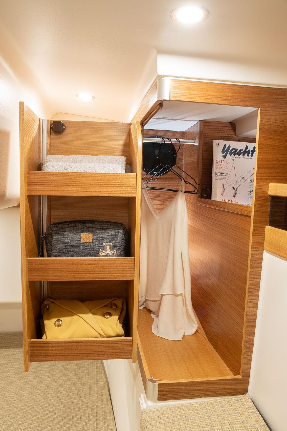 Cozy wooden closet interior on 2025 Dragonfly 40 yacht, featuring shelves and hanging space.