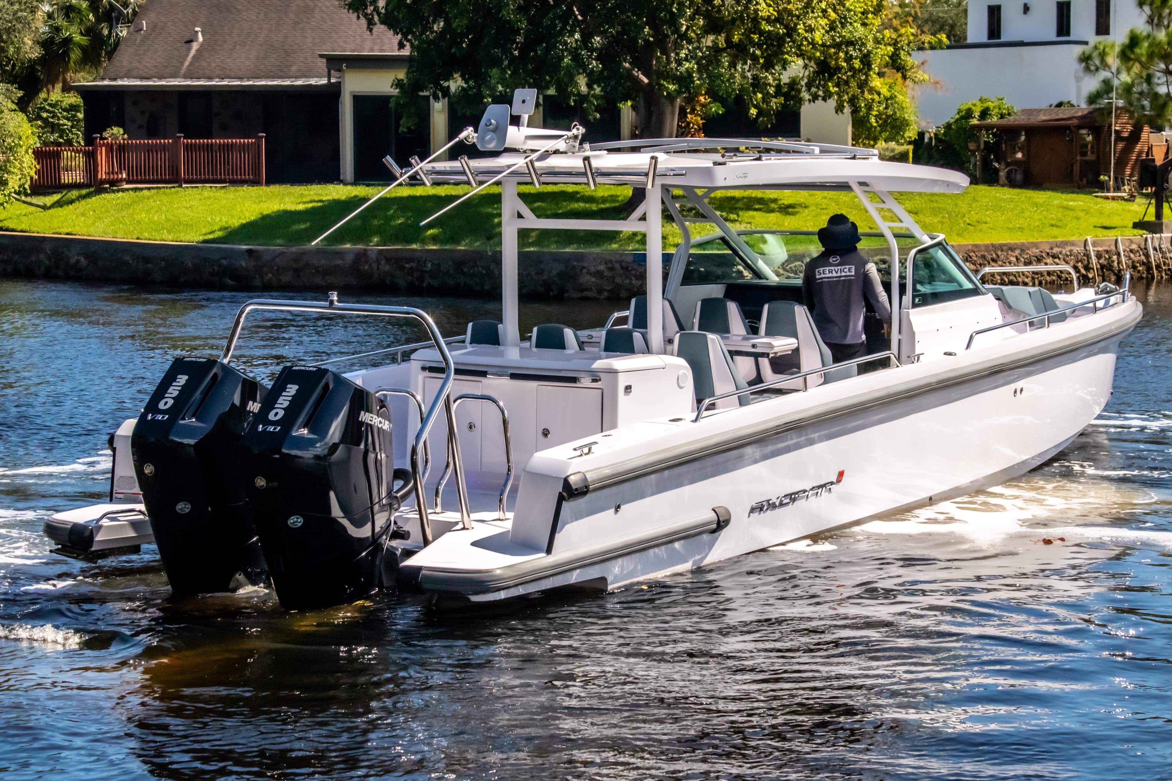 2024 Axopar 37 Sun Top boat cruising on a scenic waterway.